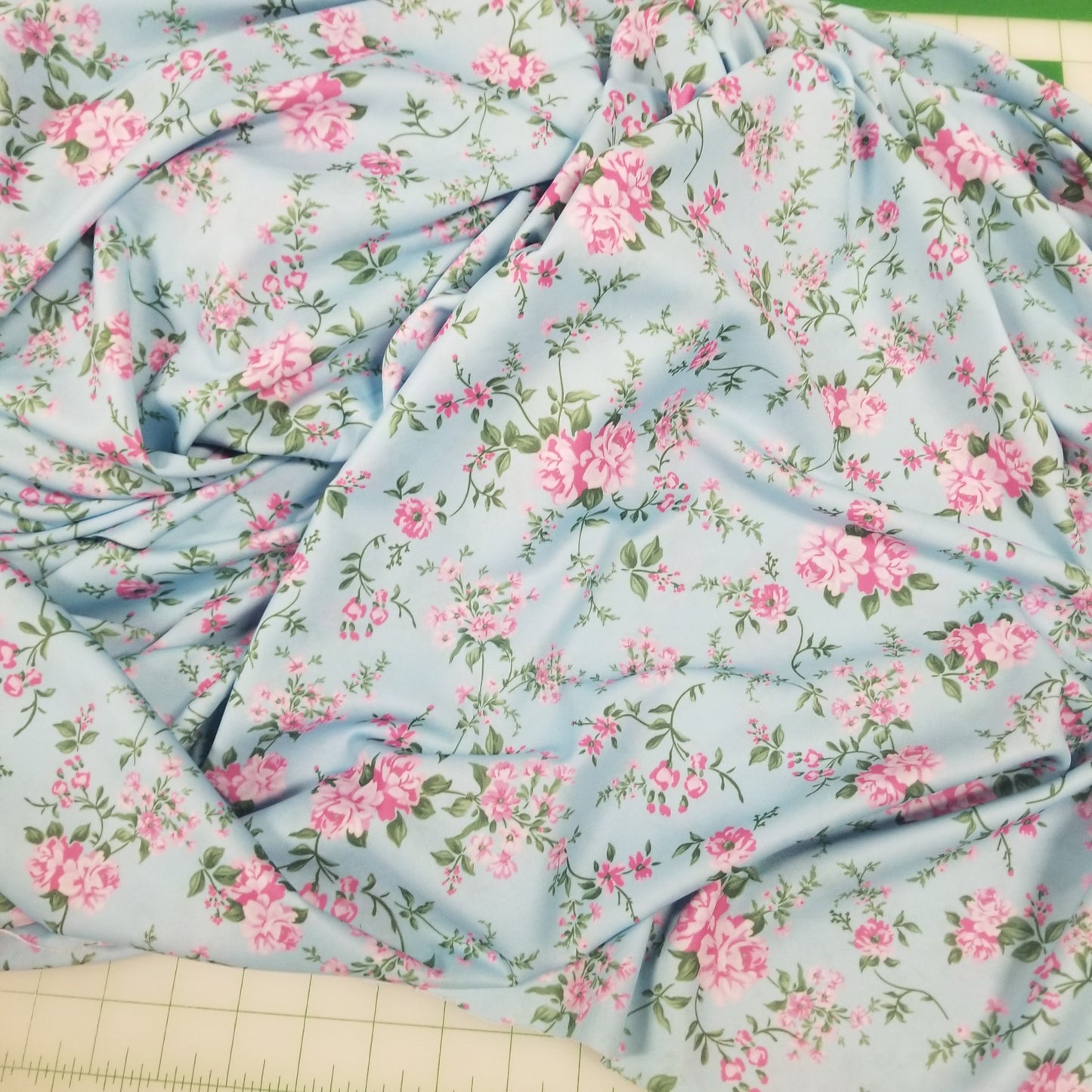 Floral fabric with pink flowers on a light blue background