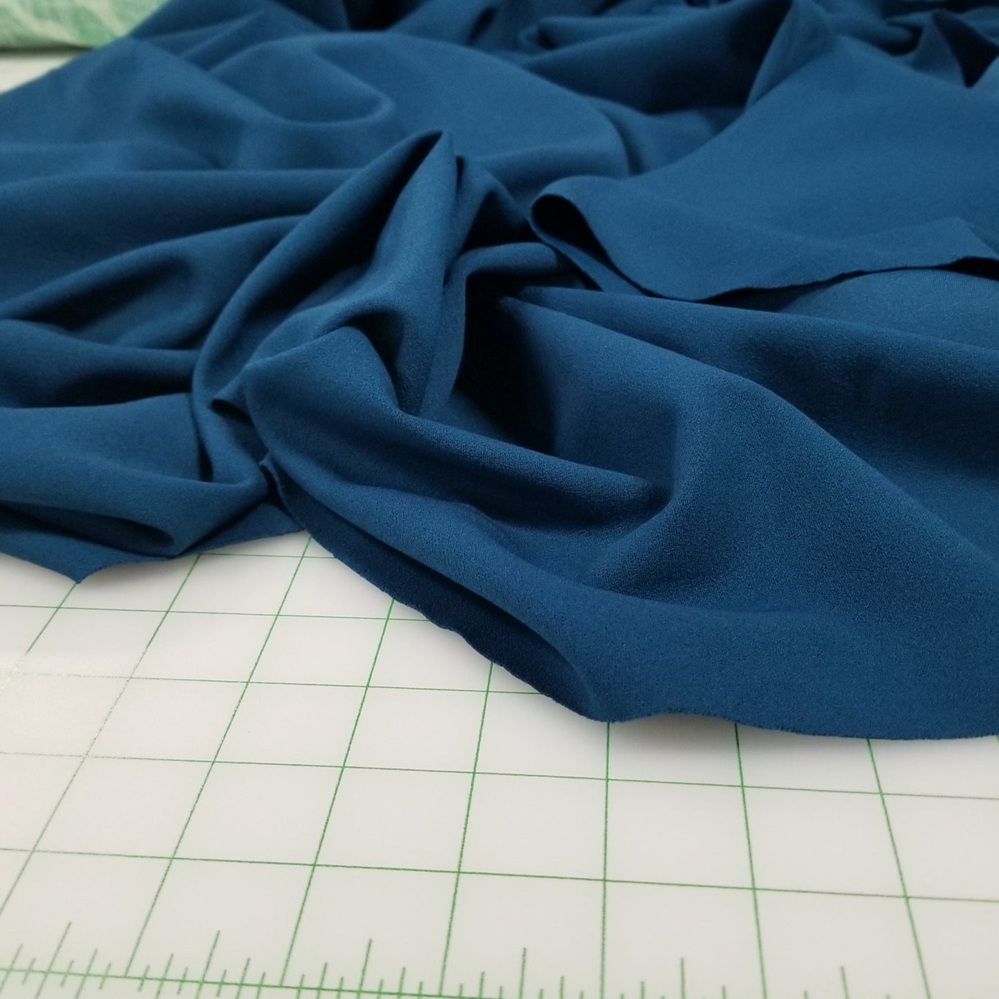 Blue fabric on a cutting mat with measurements