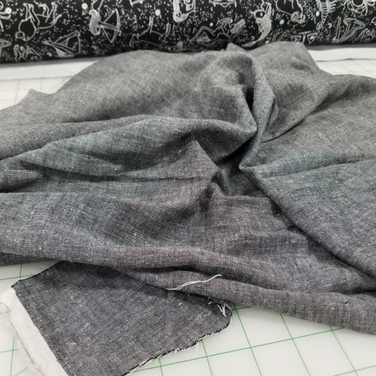 Gray fabric on a cutting mat with grid lines