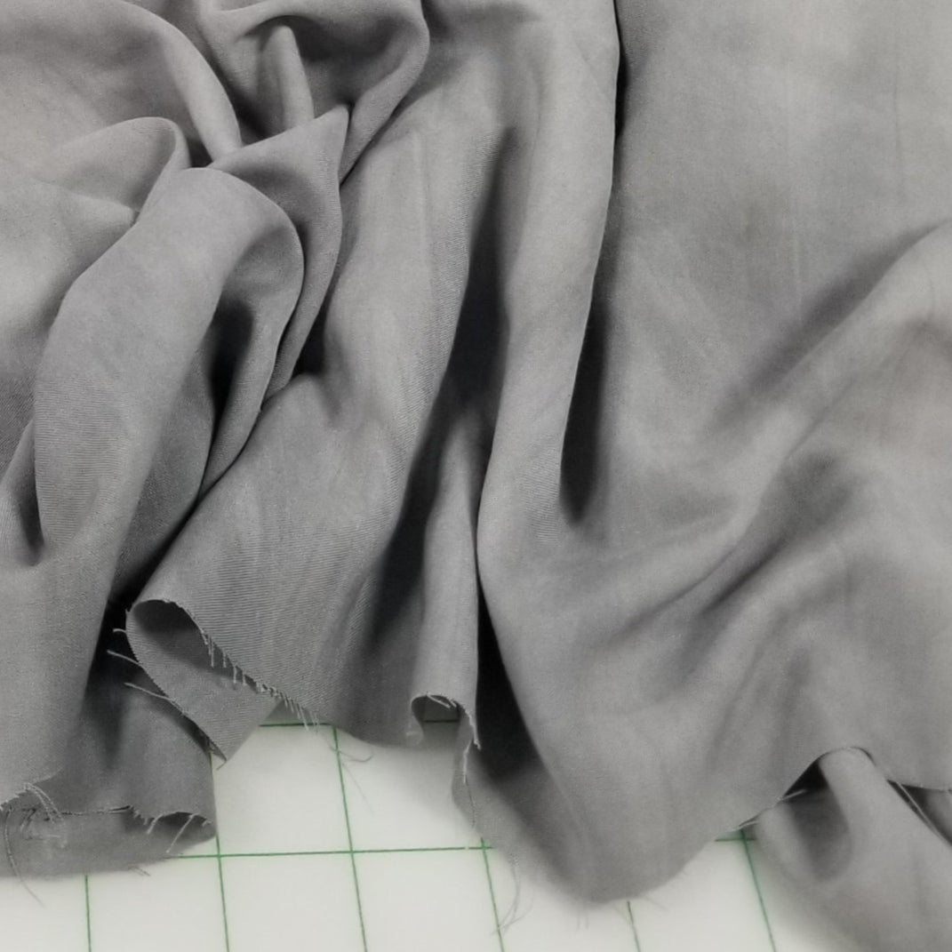 Designer Deadstock Gray fabric on a grid background
