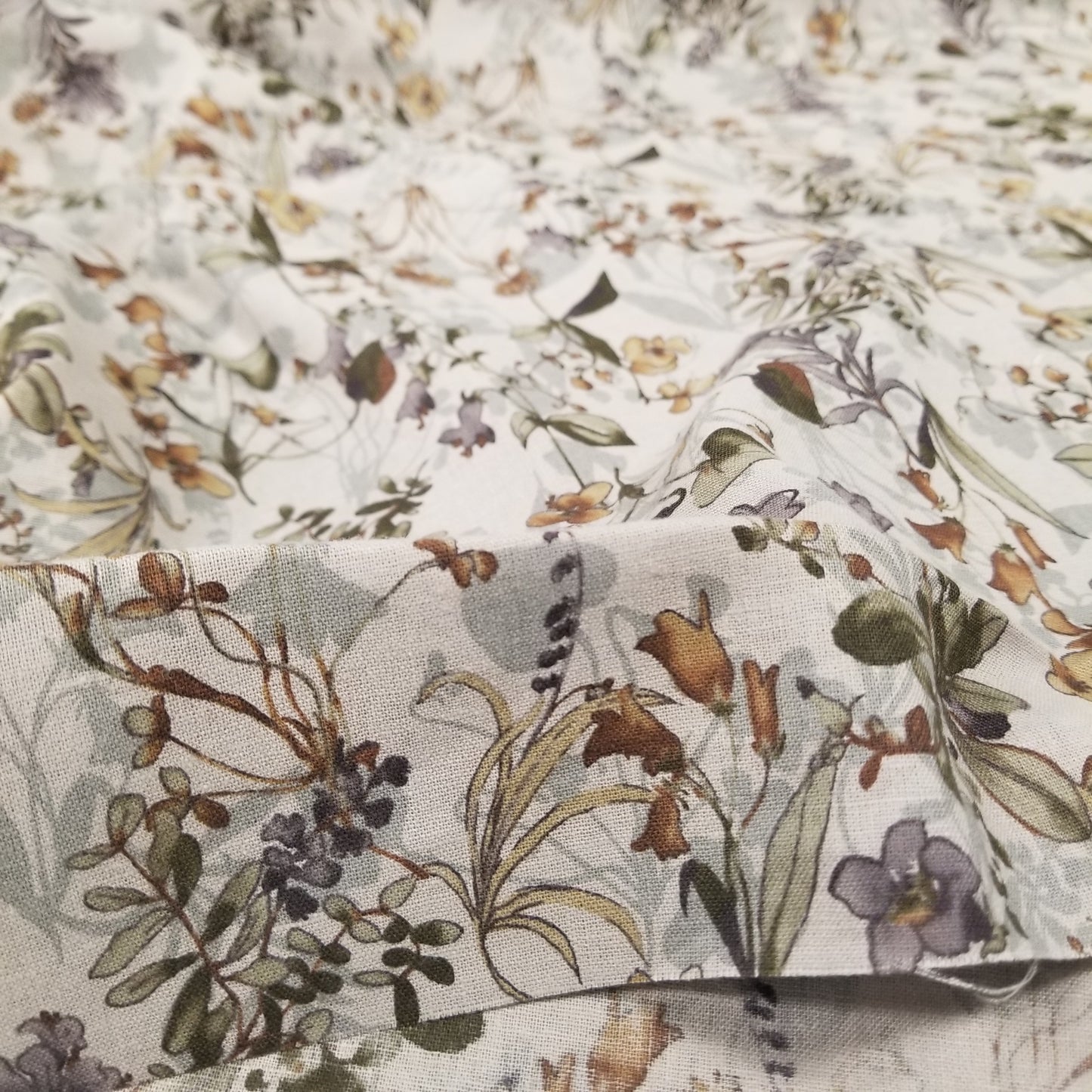 Close-up of floral fabric with a neutral color palette