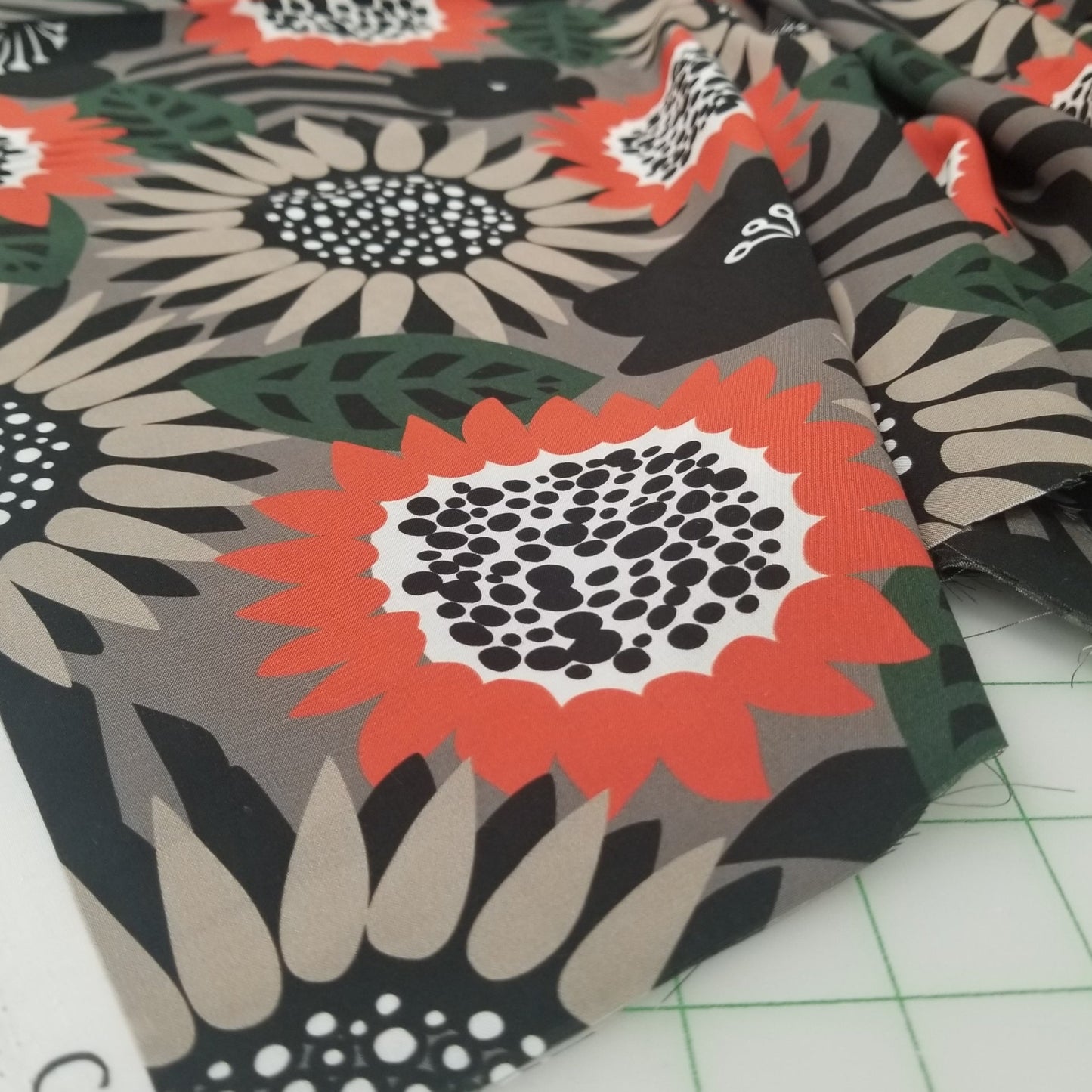 Fabric with floral and abstract patterns on a cutting mat