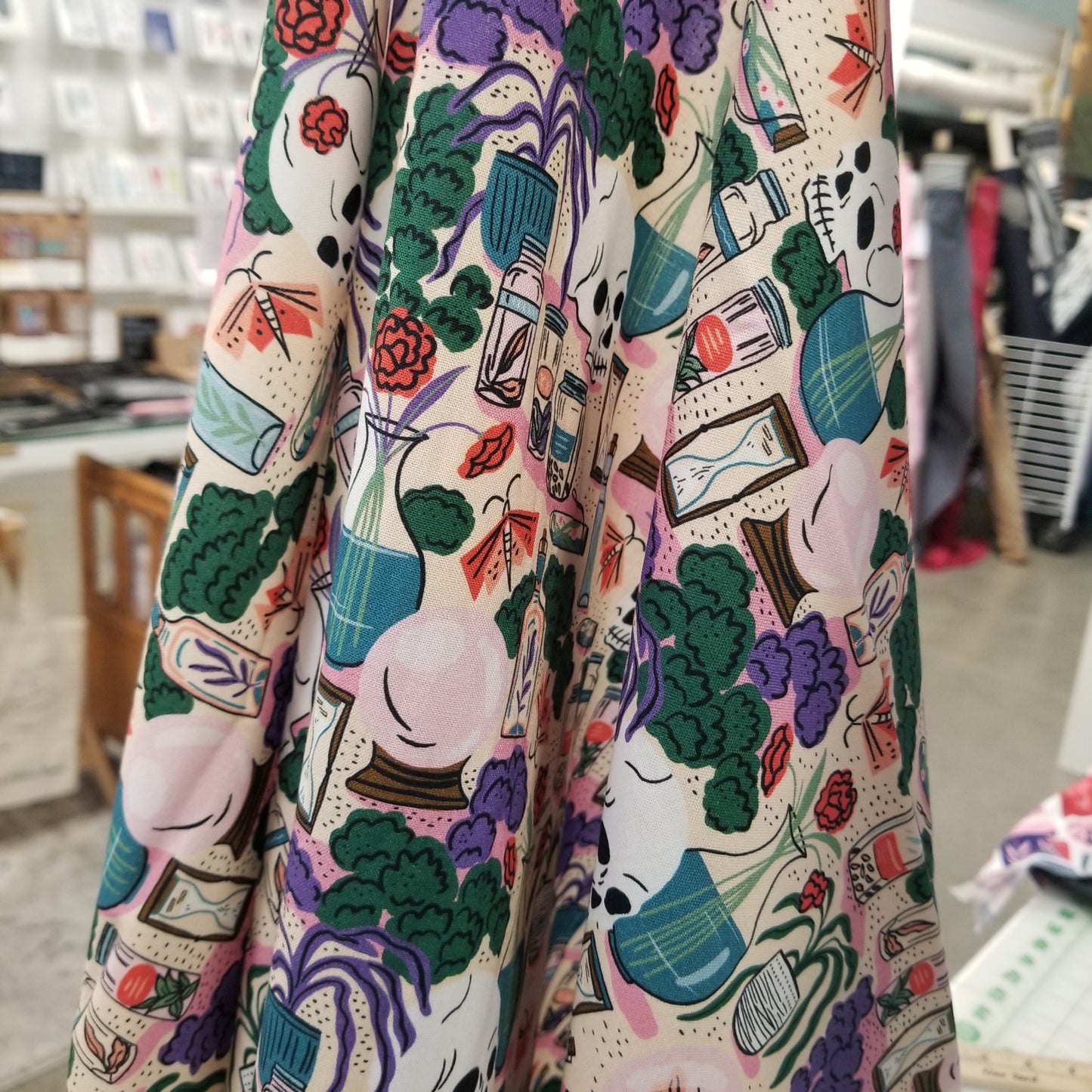 Colorful fabric with a pattern of faces and objects on a neutral background