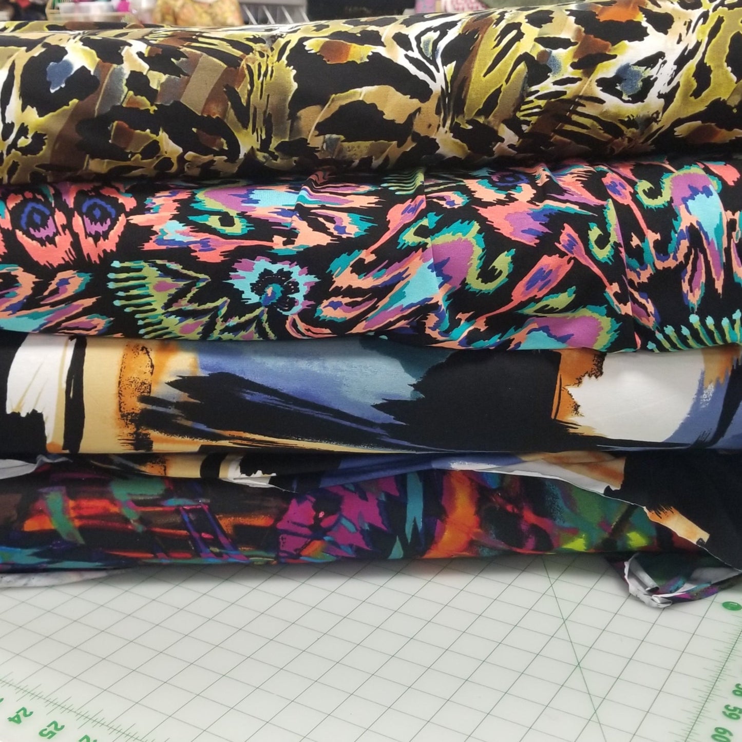 Colorful fabric swatches on a cutting mat with a ruler