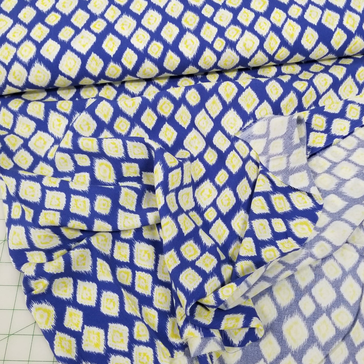 Blue and yellow checkered fabric on a cutting mat