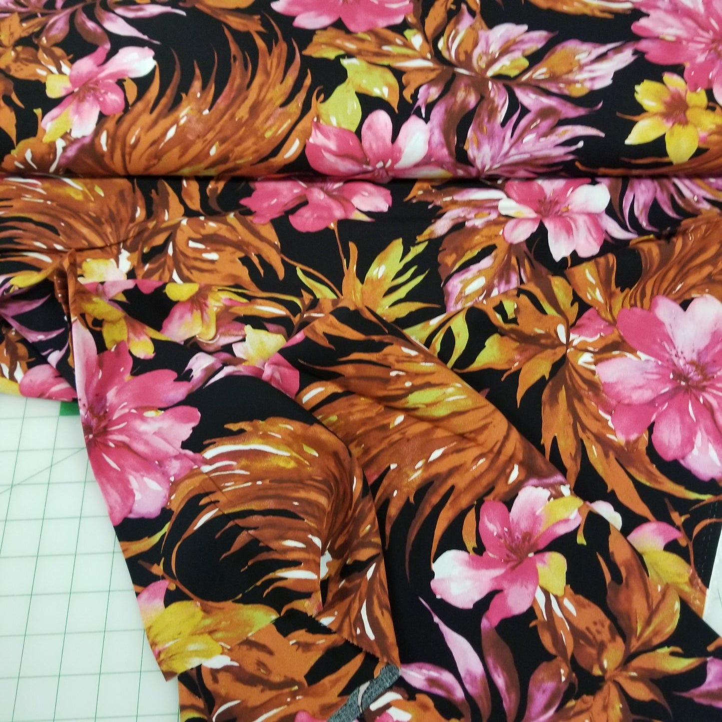 Floral and leaf patterned fabric on a grid background