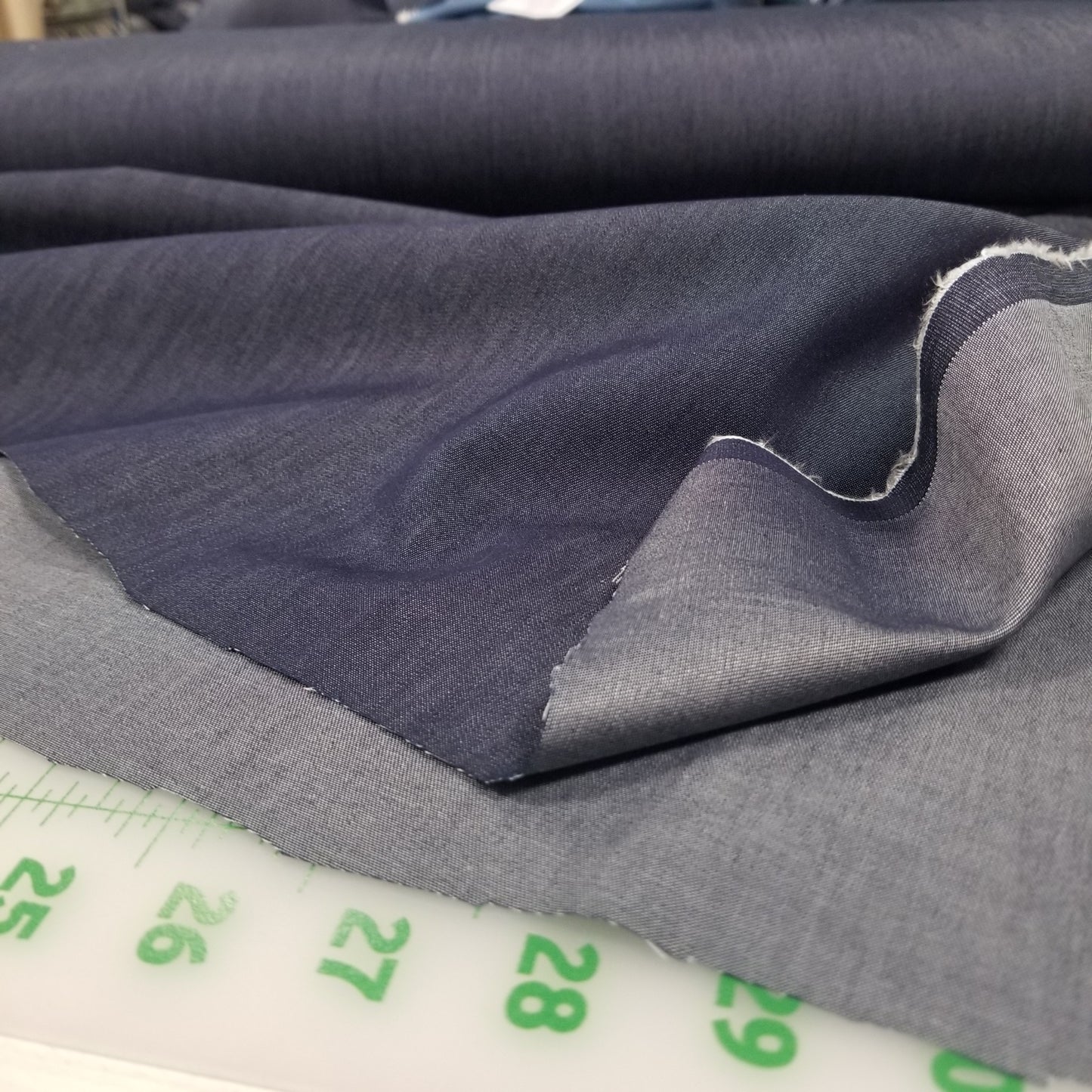 Gray fabric with a measuring tape showing measurements