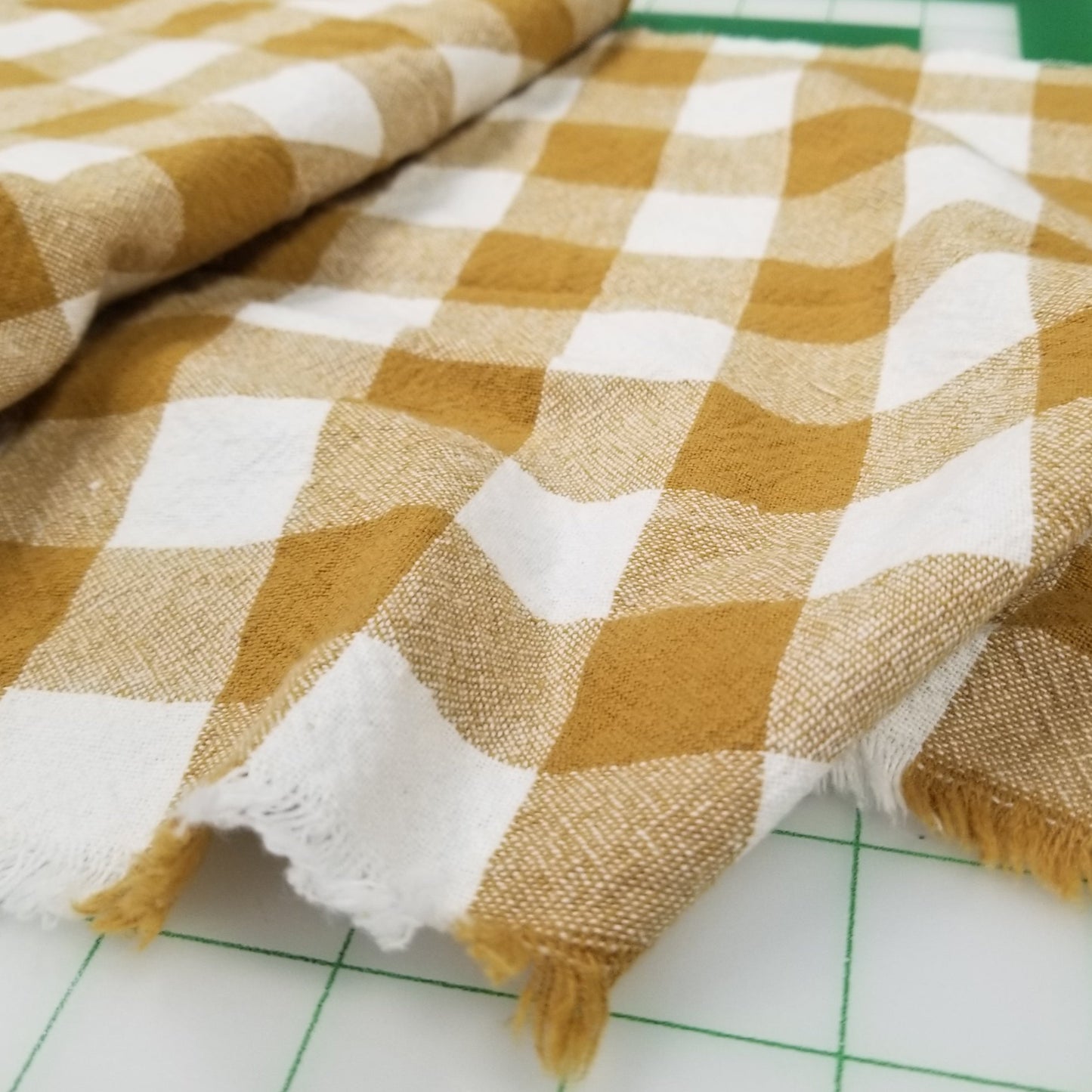 Checkered fabric with yellow and white pattern on a grid background