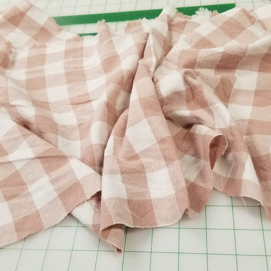 Pink and white checkered fabric on a green grid background