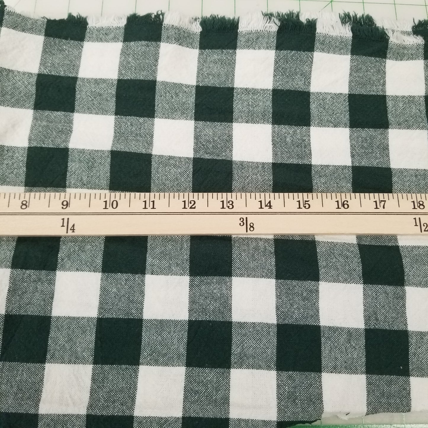 Black and white checkered fabric with a ruler for scale