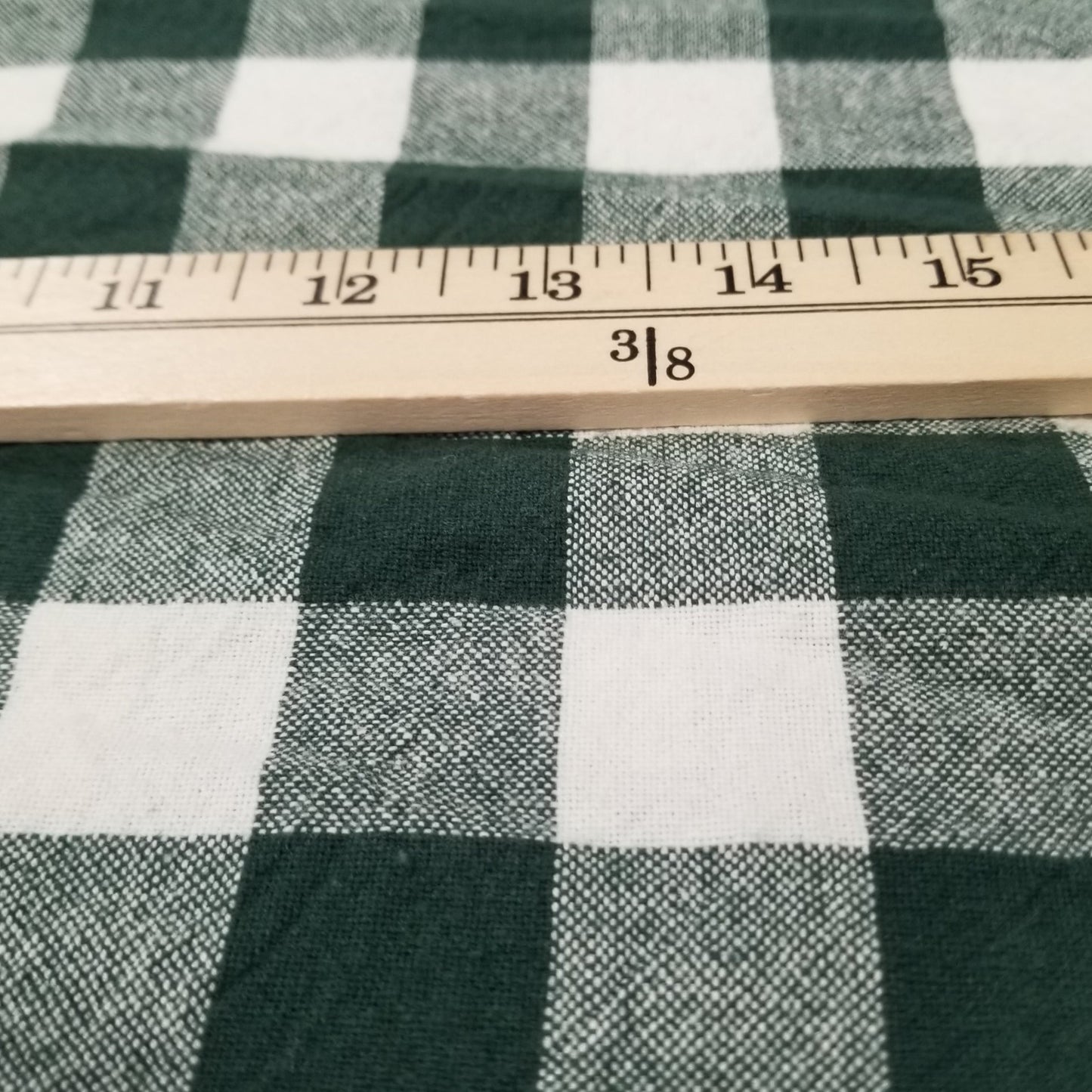 Green and white checkered fabric with a ruler for scale