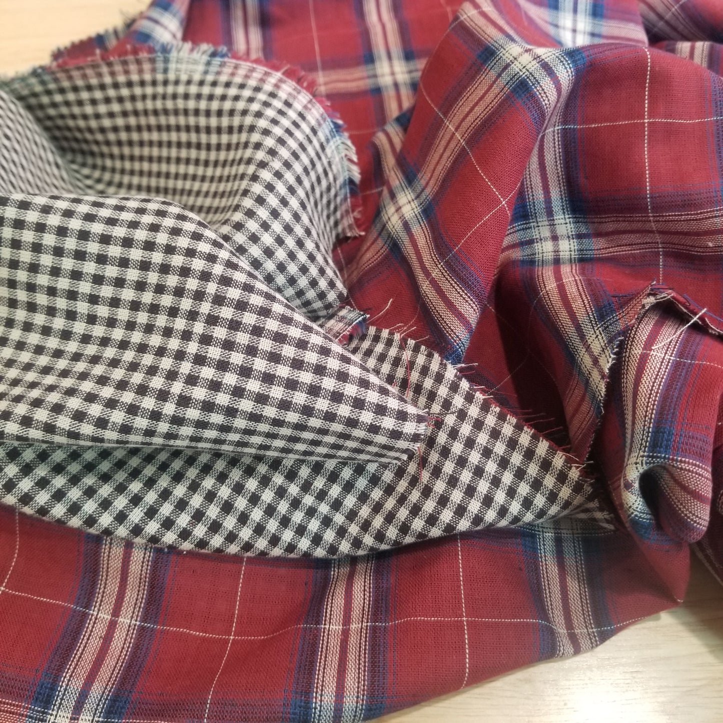 Plaid and checkered fabric swatches in red, blue, white, and black.