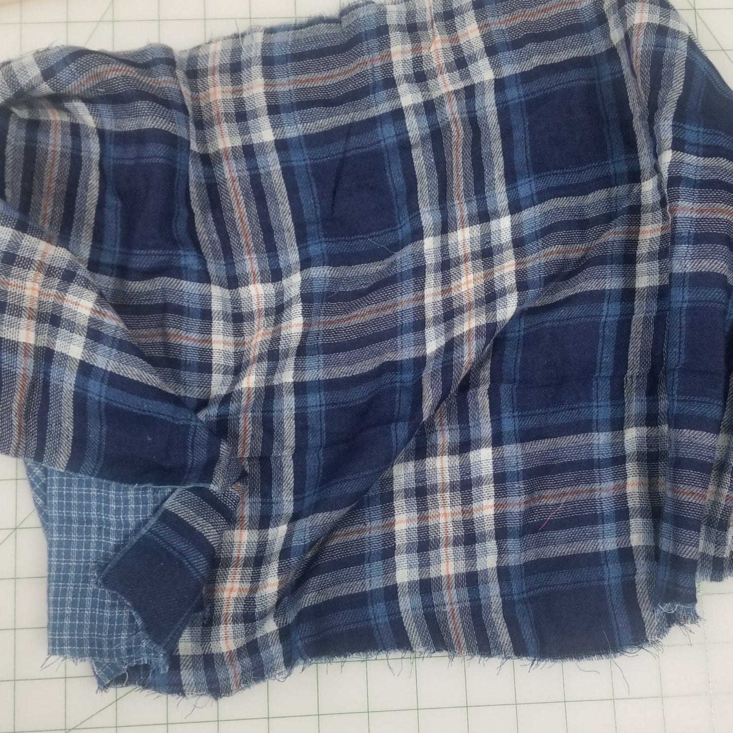 Blue plaid fabric on a white grid background. double gauze reverse