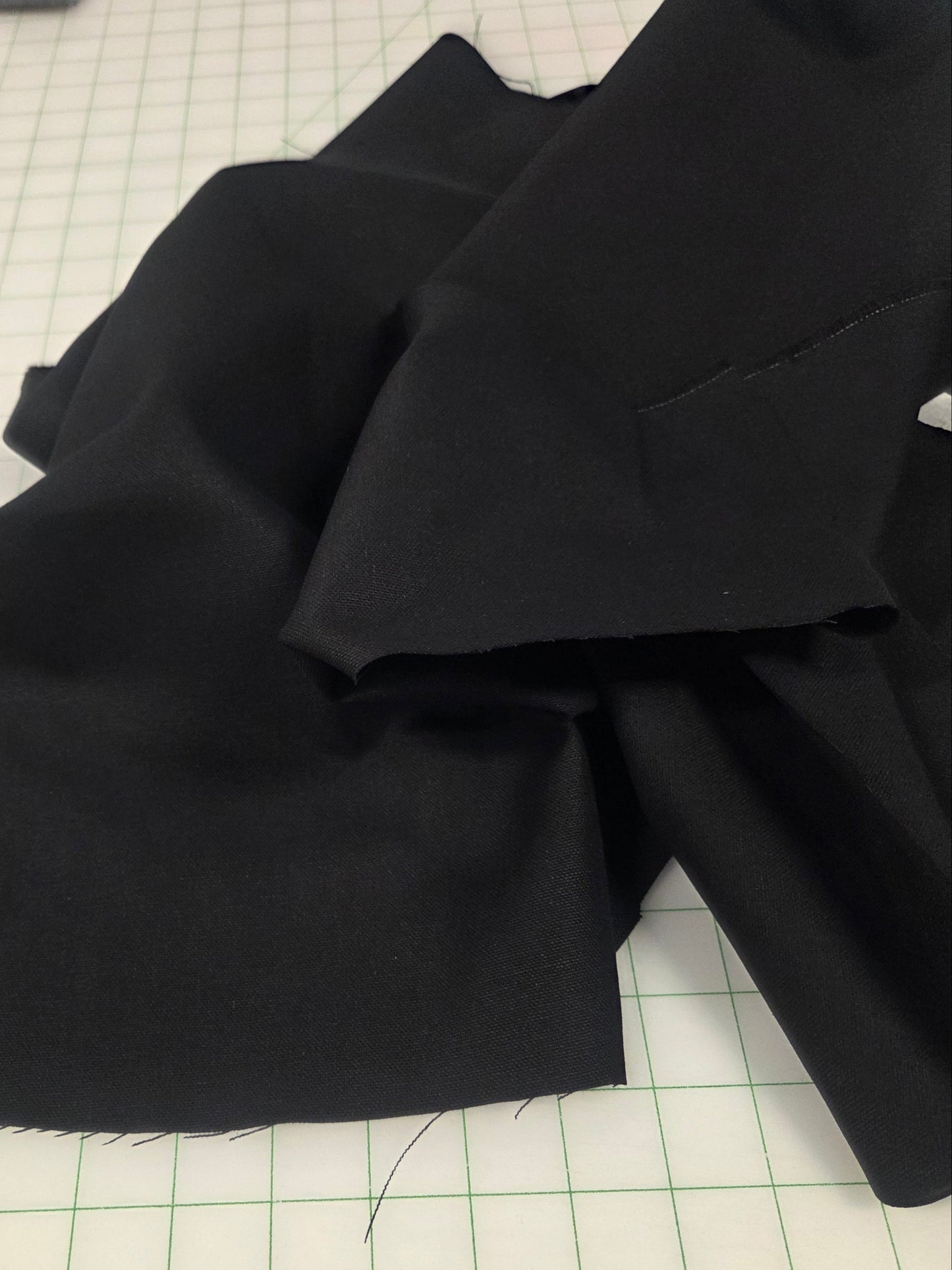 Black fabric on a grid-patterned cutting mat