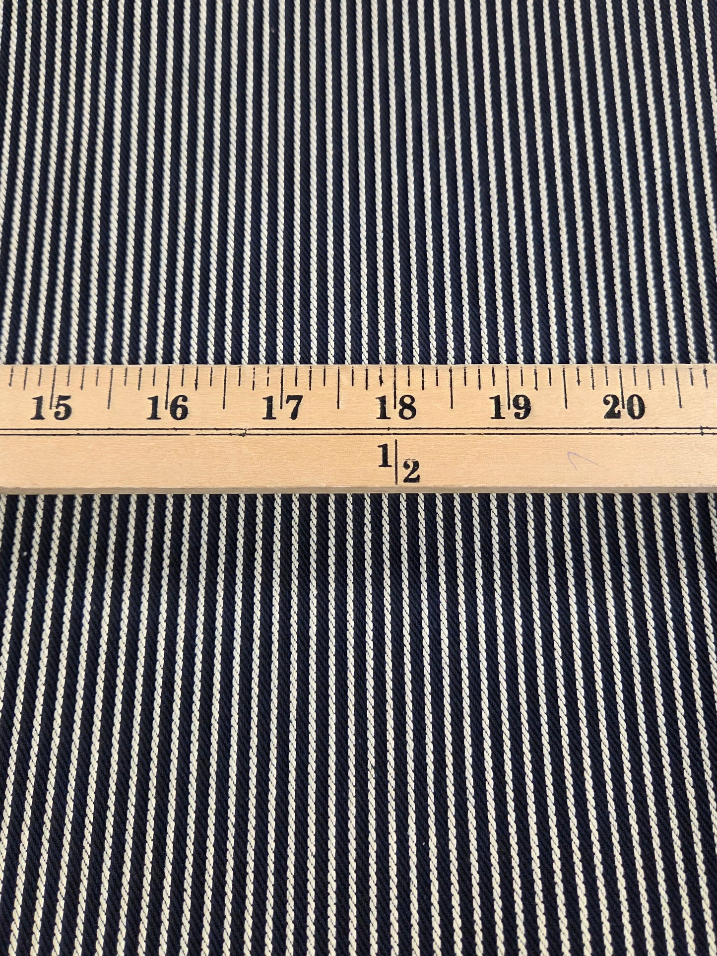 Navy and white striped fabric with a ruler for scale. LA FInch Fabrics Denim