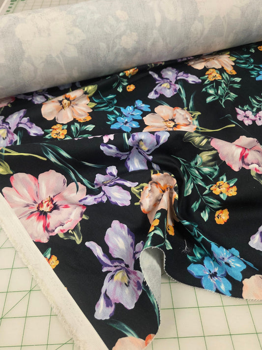 Floral-patterned fabric on a cutting mat with a grid pattern. fashion fabric