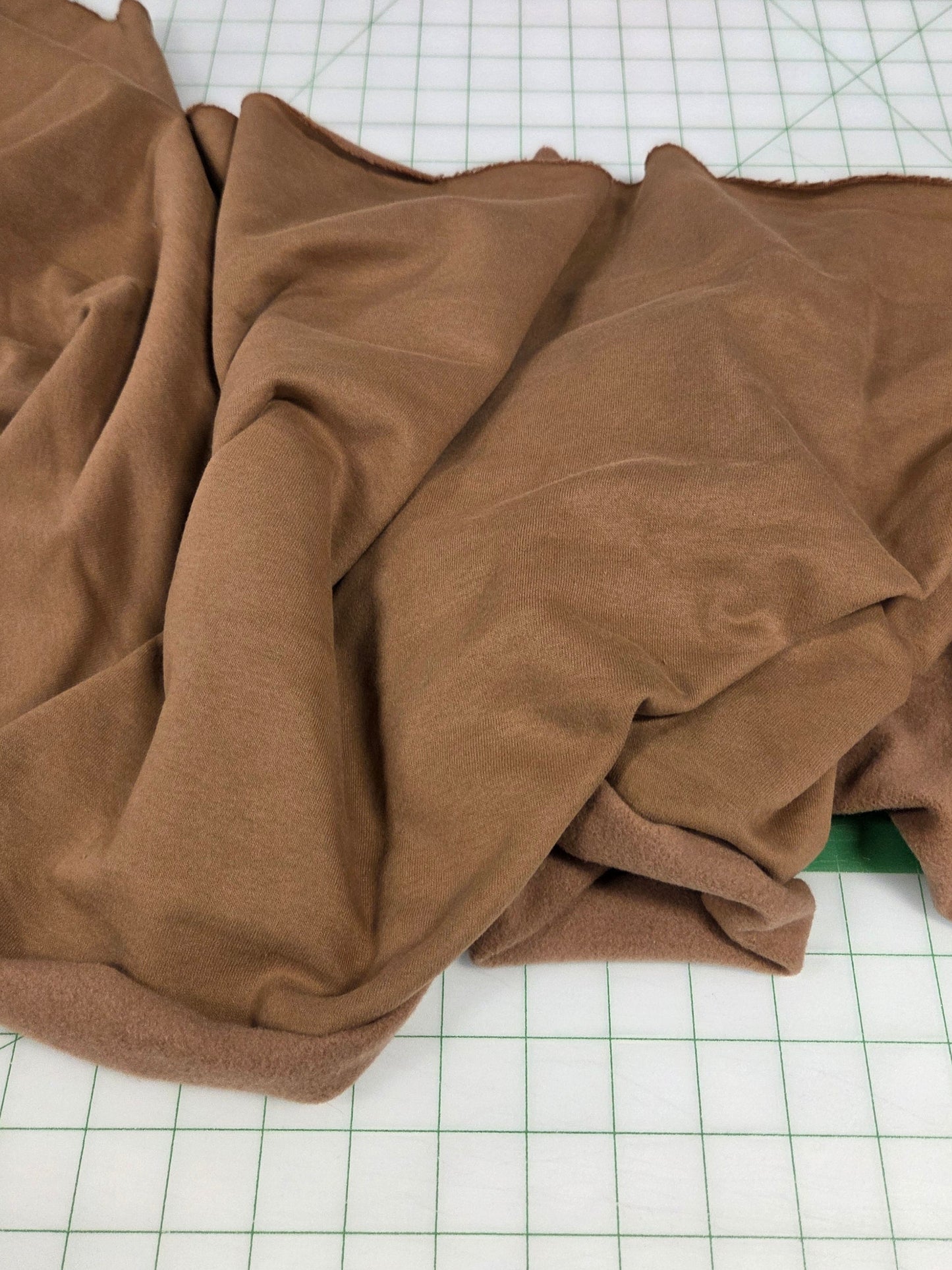 Brown fabric on a grid surface, sweatshirt fleece