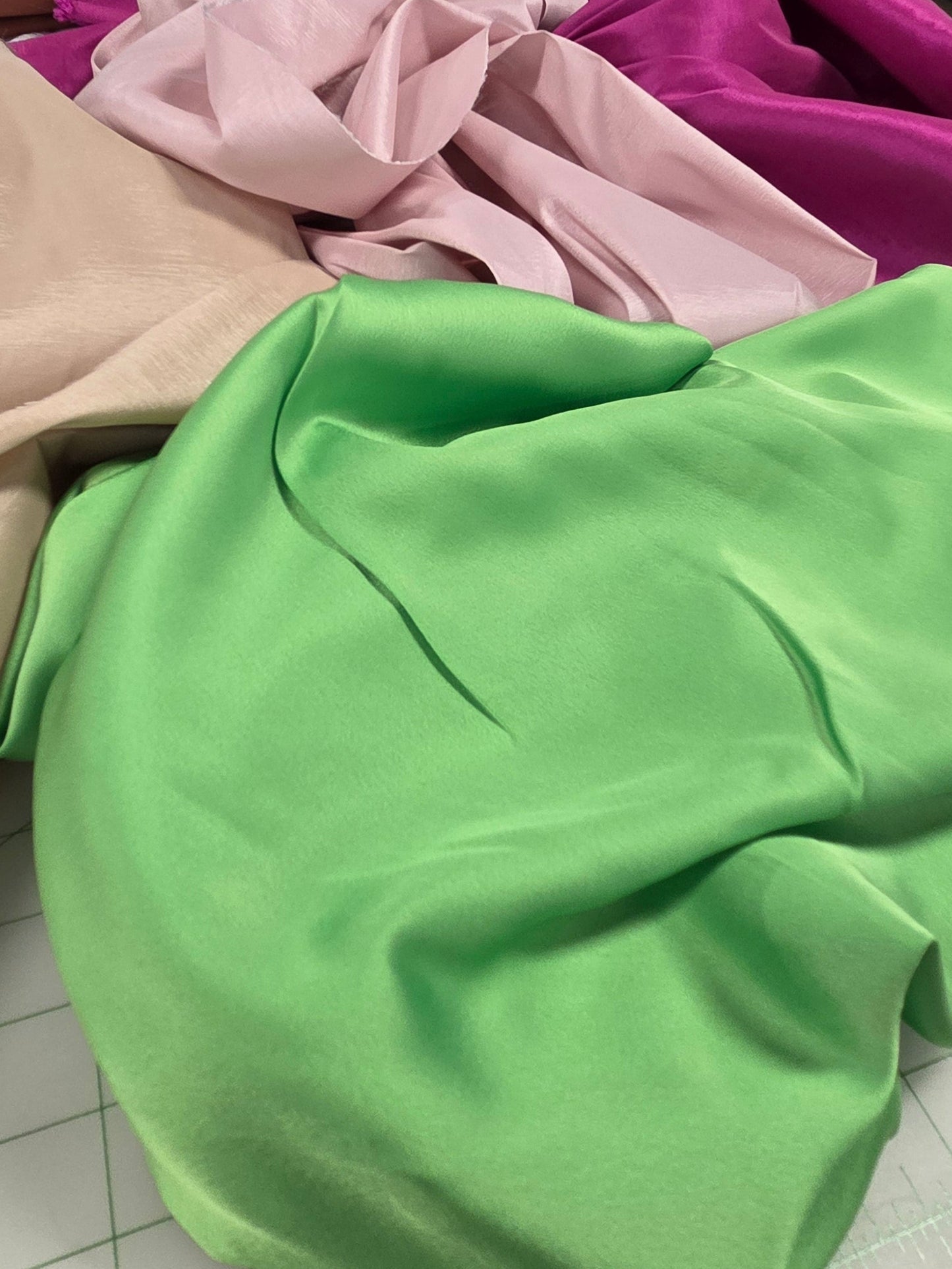 group of bridal wear solids. green fabric up close to show sheen. retail fabric by the yard