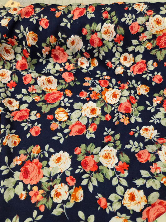 Floral fabric with red, orange, and white flowers on a navy background