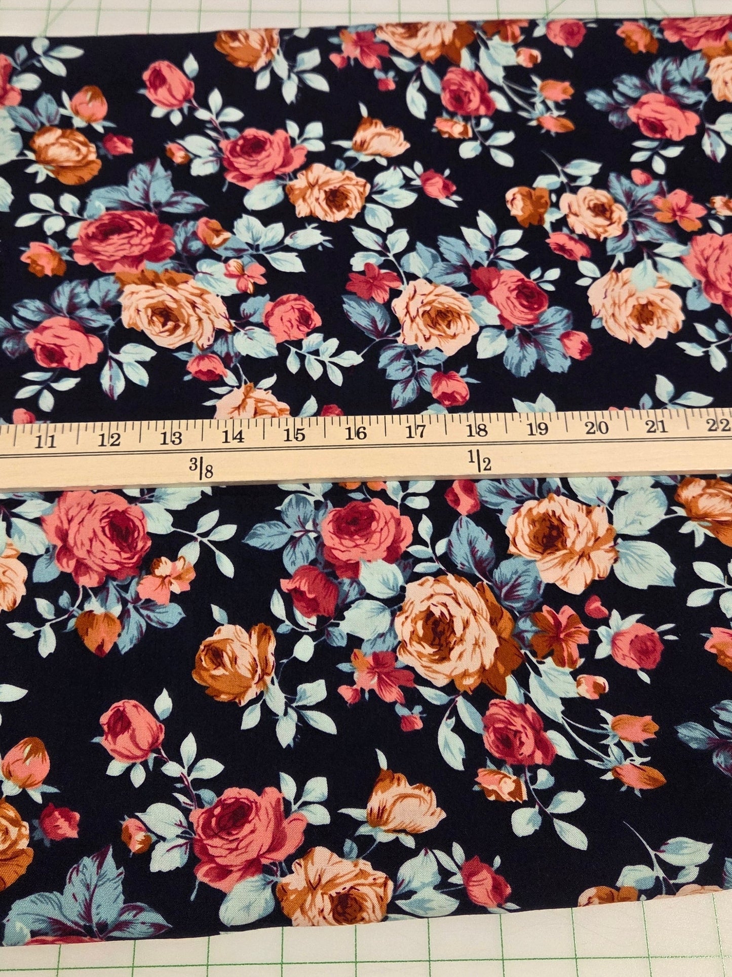Floral fabric with a measuring tape on a grid background
