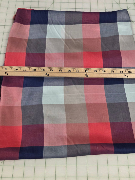 Plaid fabric on a cutting mat with a ruler for measurement