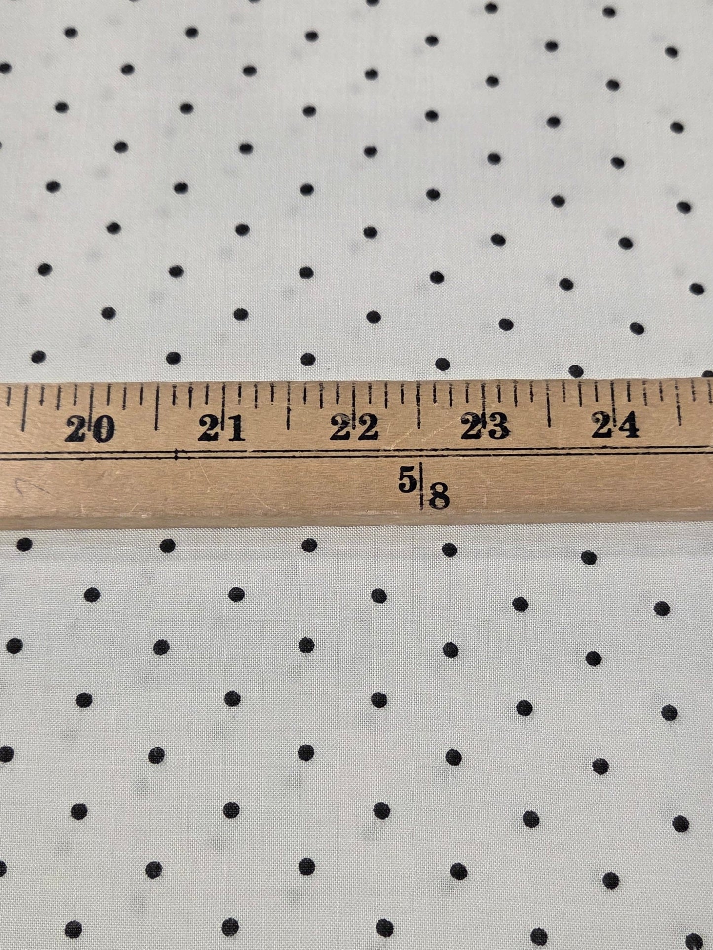 rayon challis dot woven with micro black dots on an ivory rayon