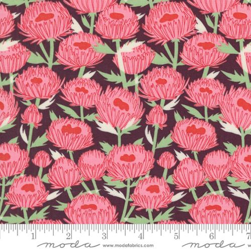 Patterned fabric with pink flowers on a dark background, featuring Moda label.