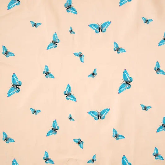 Pattern of blue butterflies on a beige background