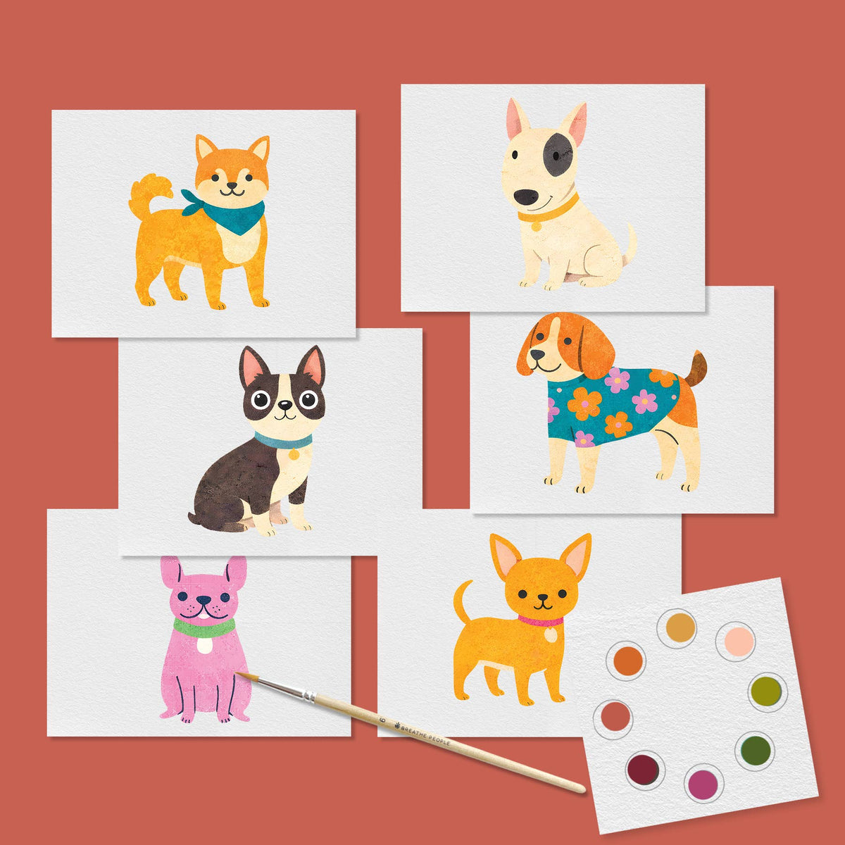 Six illustrated dog art prints arranged on a terracotta background, with a paintbrush and a small paint palette visible. The dogs are drawn in various colors and poses, and no brand text is visible. analog activity sold for crafting projexts
