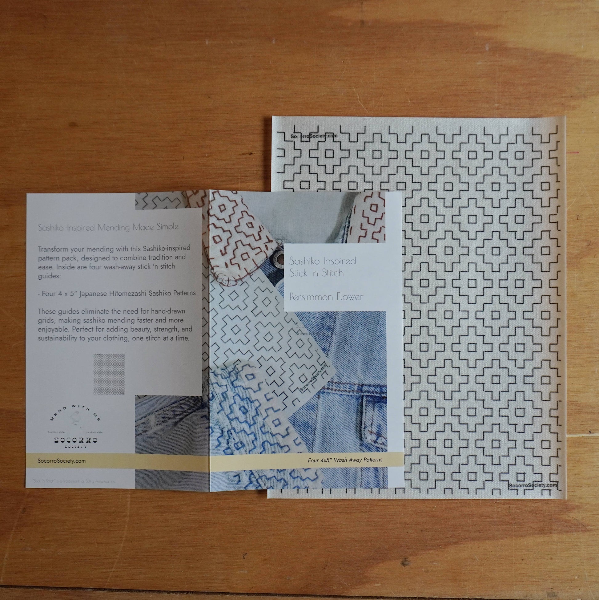 Patterned fabric swatches and a book on a wooden surface