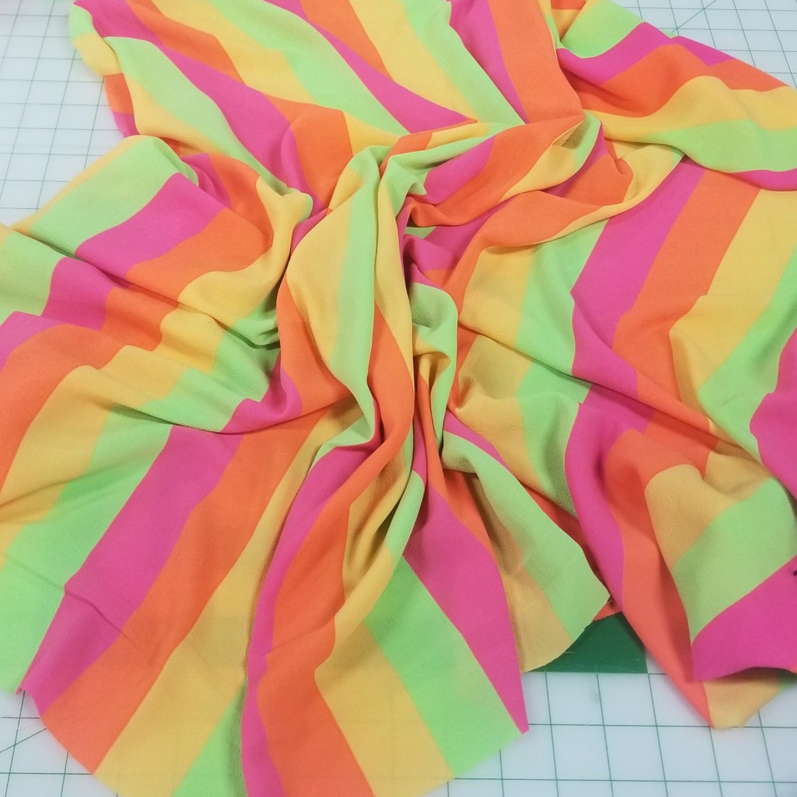 Colorful striped fabric on a grid background