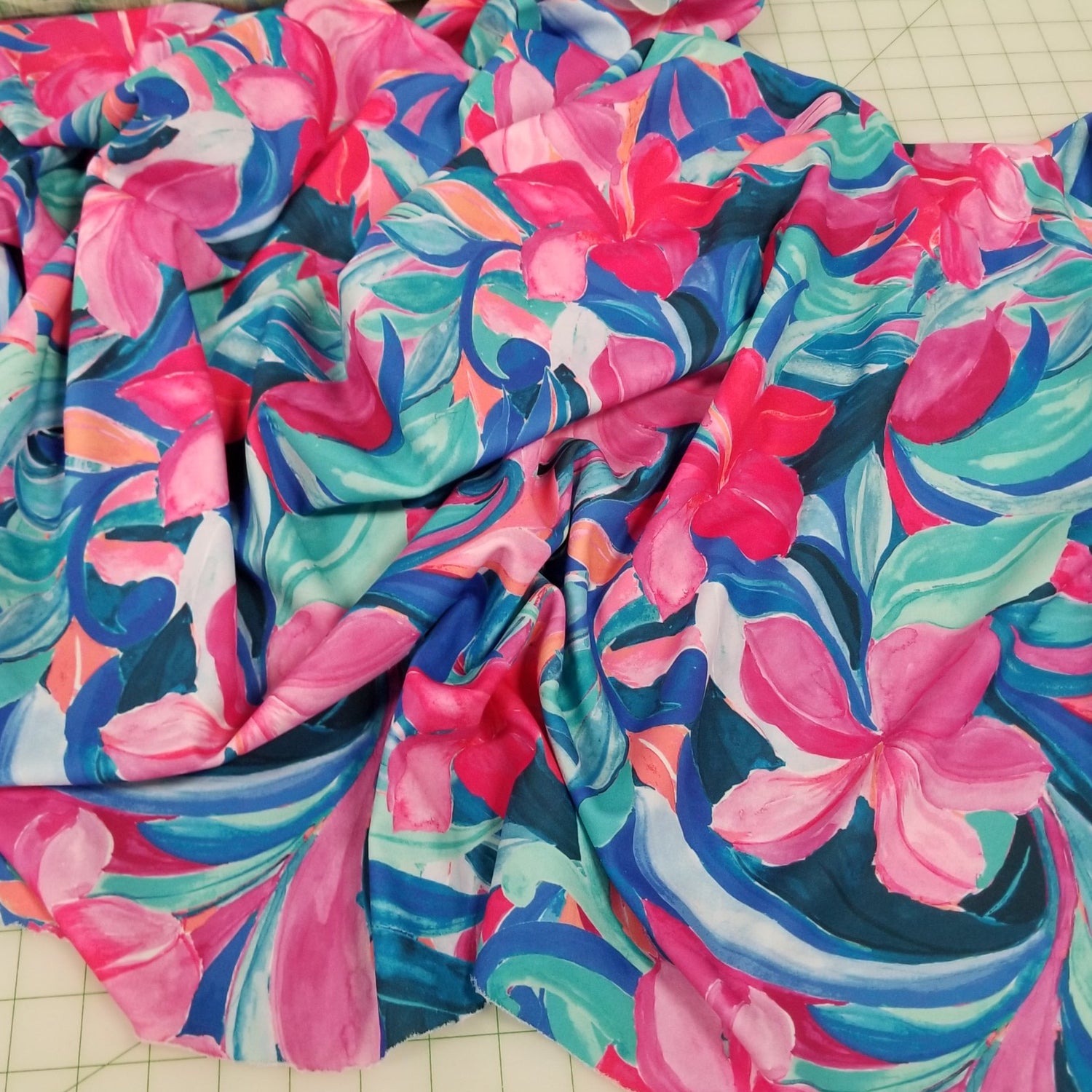 Colorful floral fabric on a cutting mat