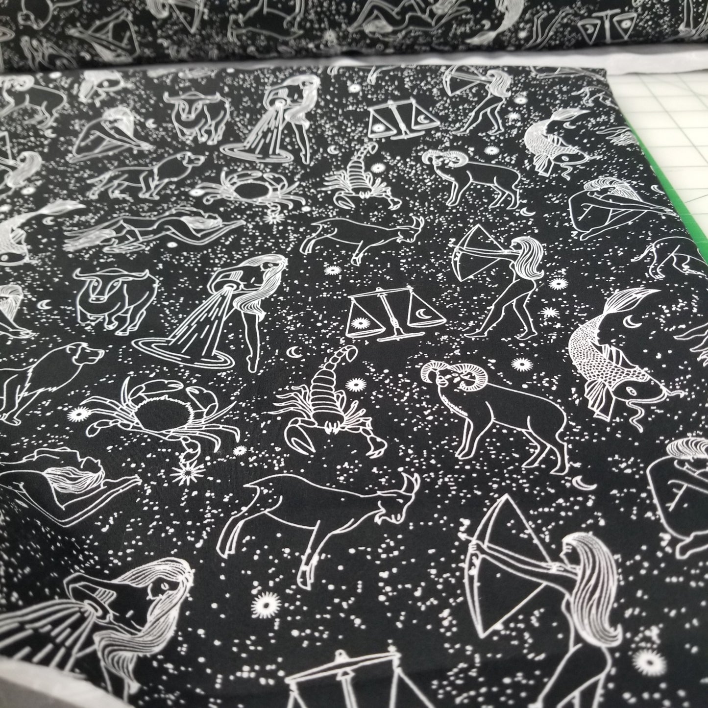 Pattern of zodiac signs on a black background with white lines