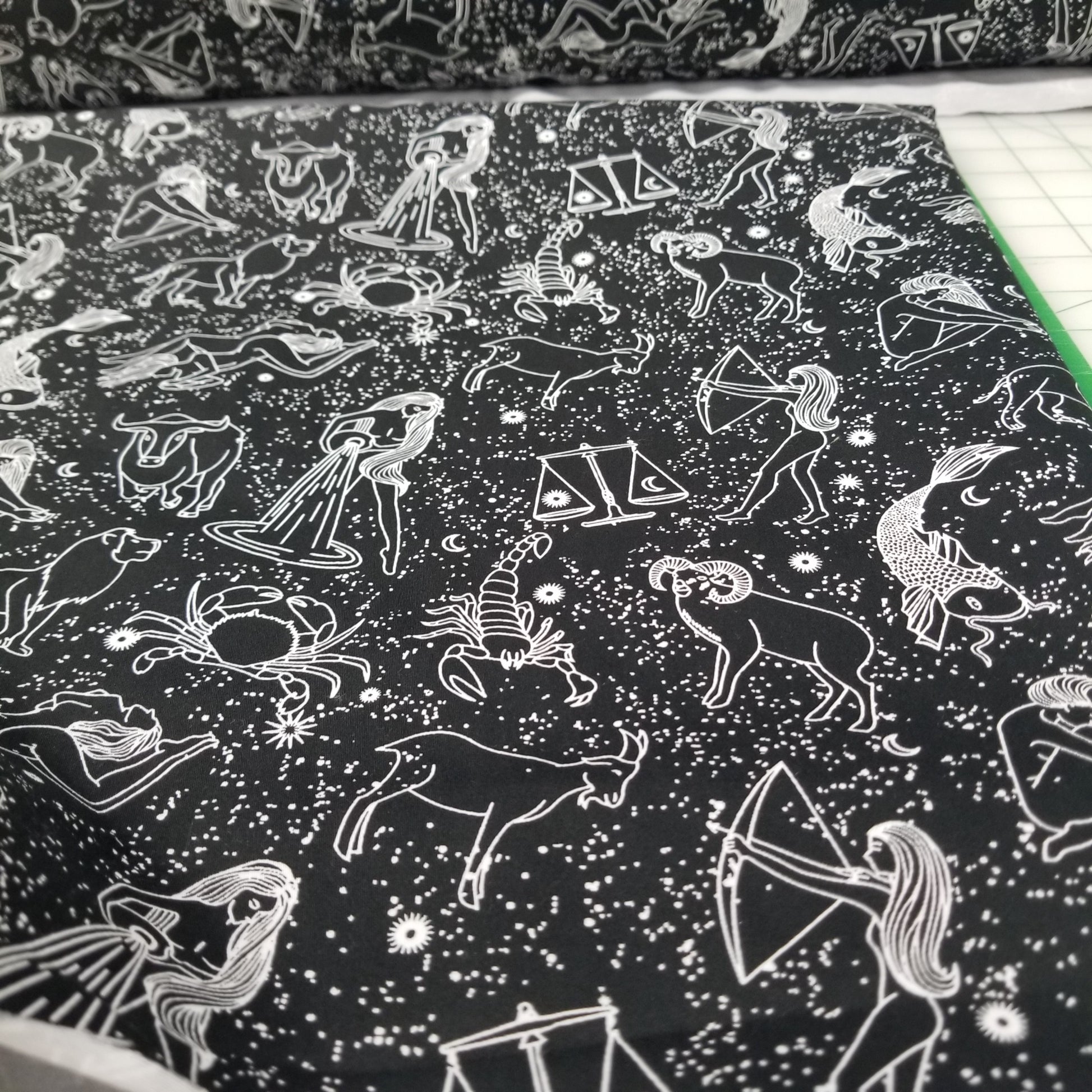 Pattern of zodiac signs on a black background with white lines