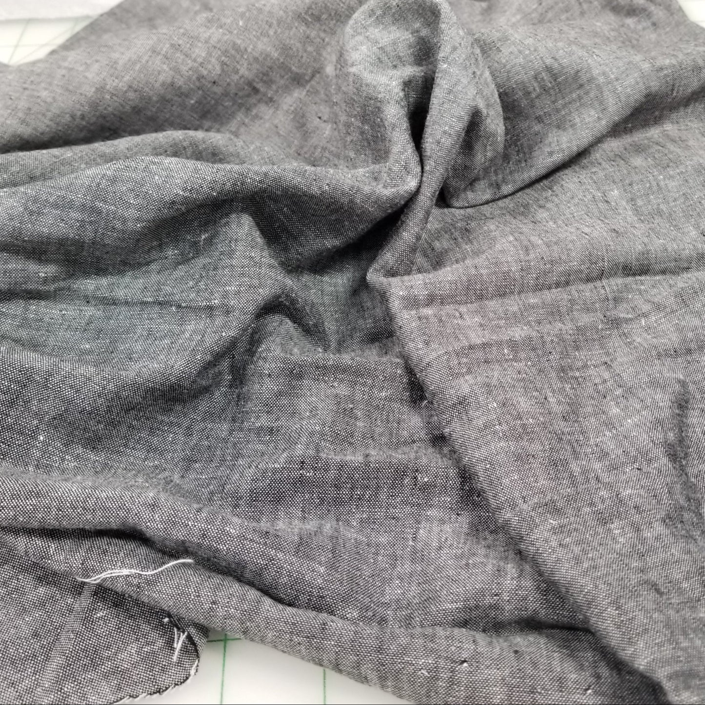 Close-up of gray fabric with a textured pattern on a white background