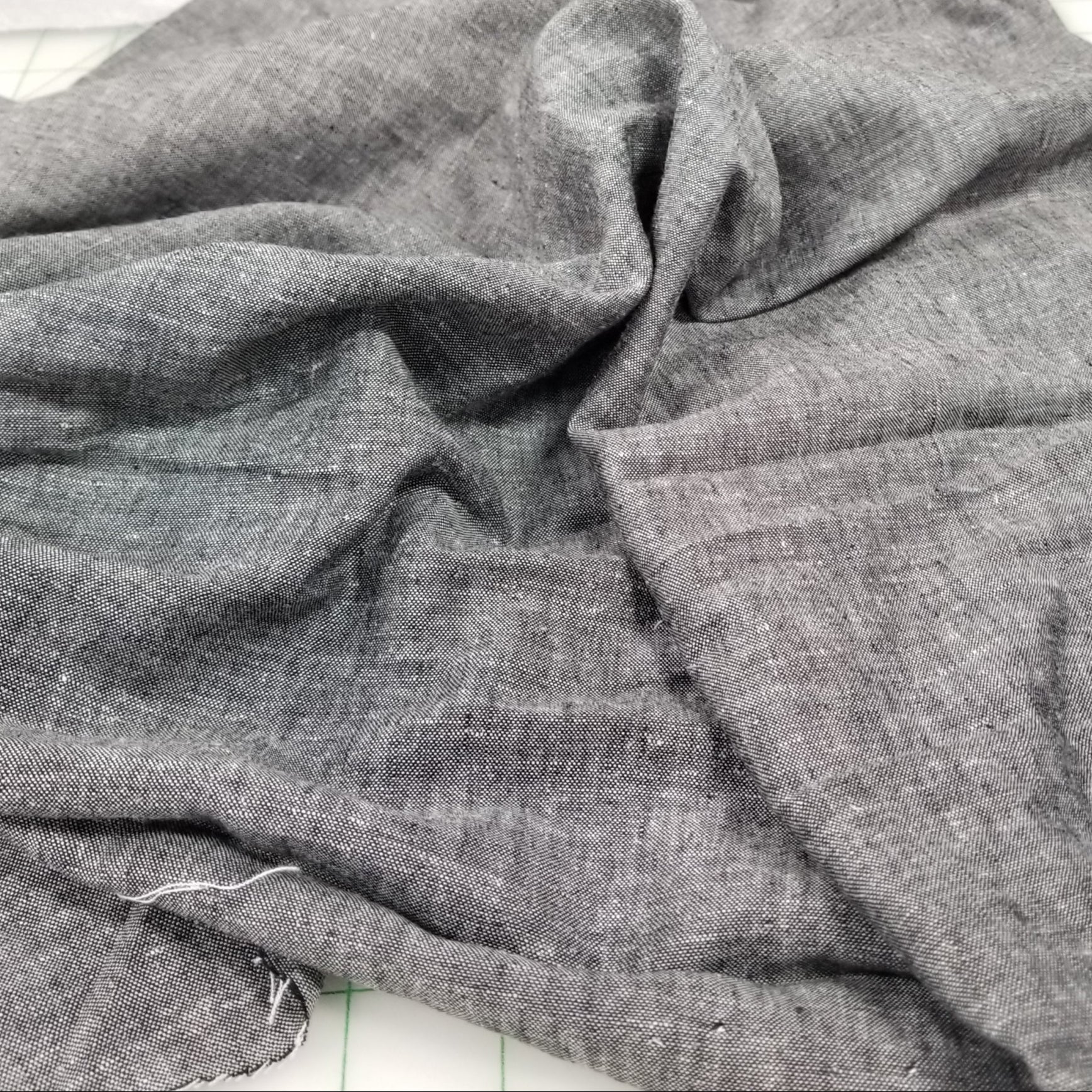 Close-up of gray fabric with a textured pattern on a white background