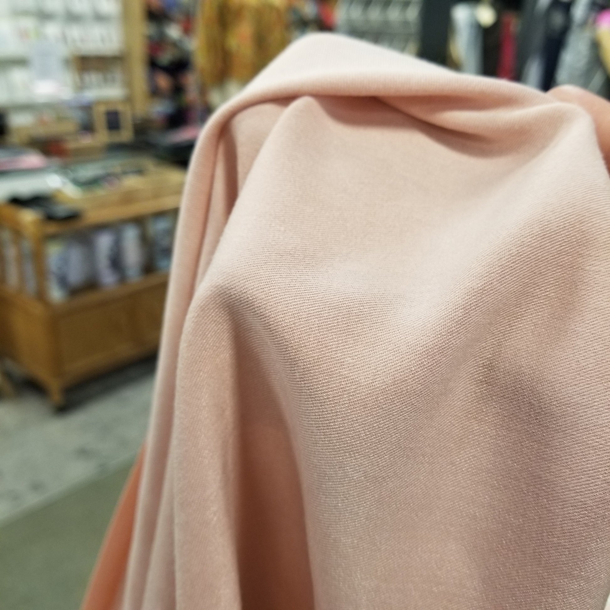 Close-up of beige fabric with a blurred store background