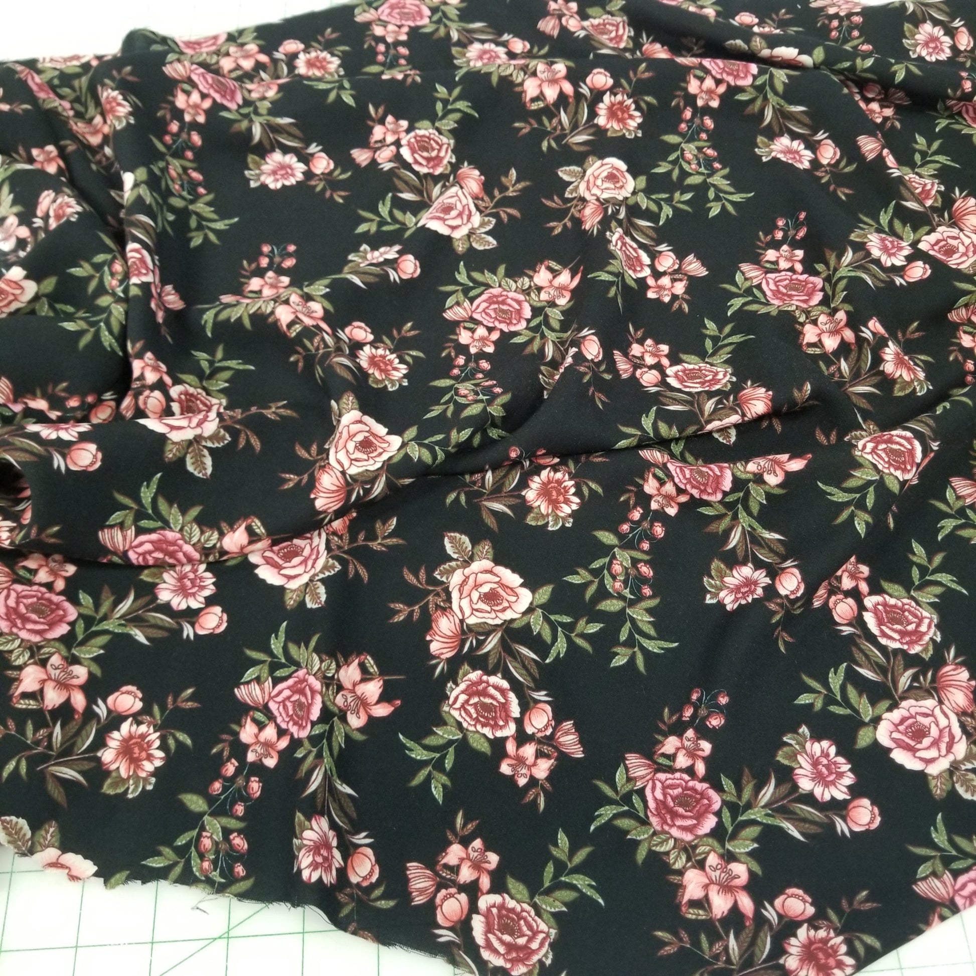 Floral fabric with pink flowers on a black background