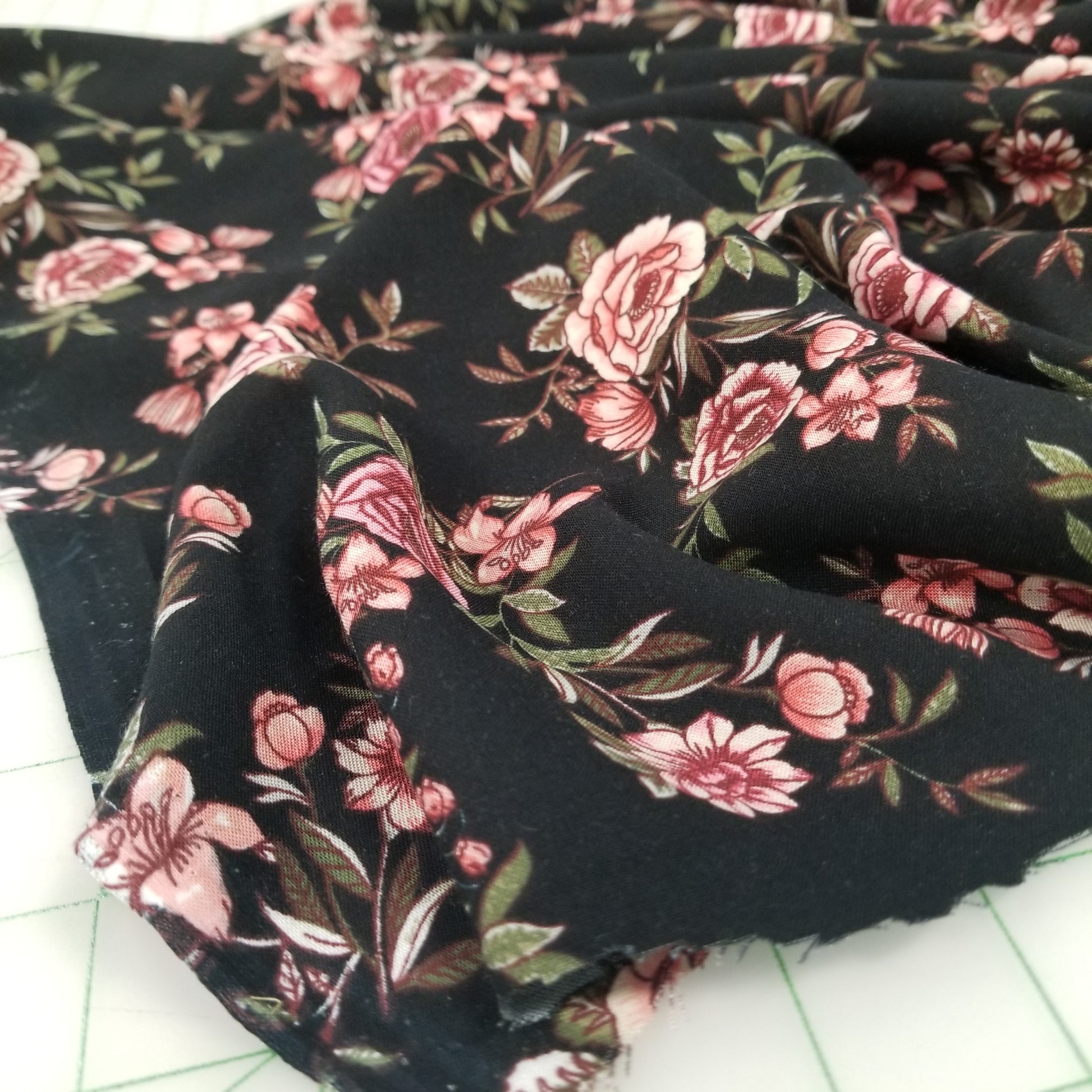 Floral fabric with pink flowers on a black background
