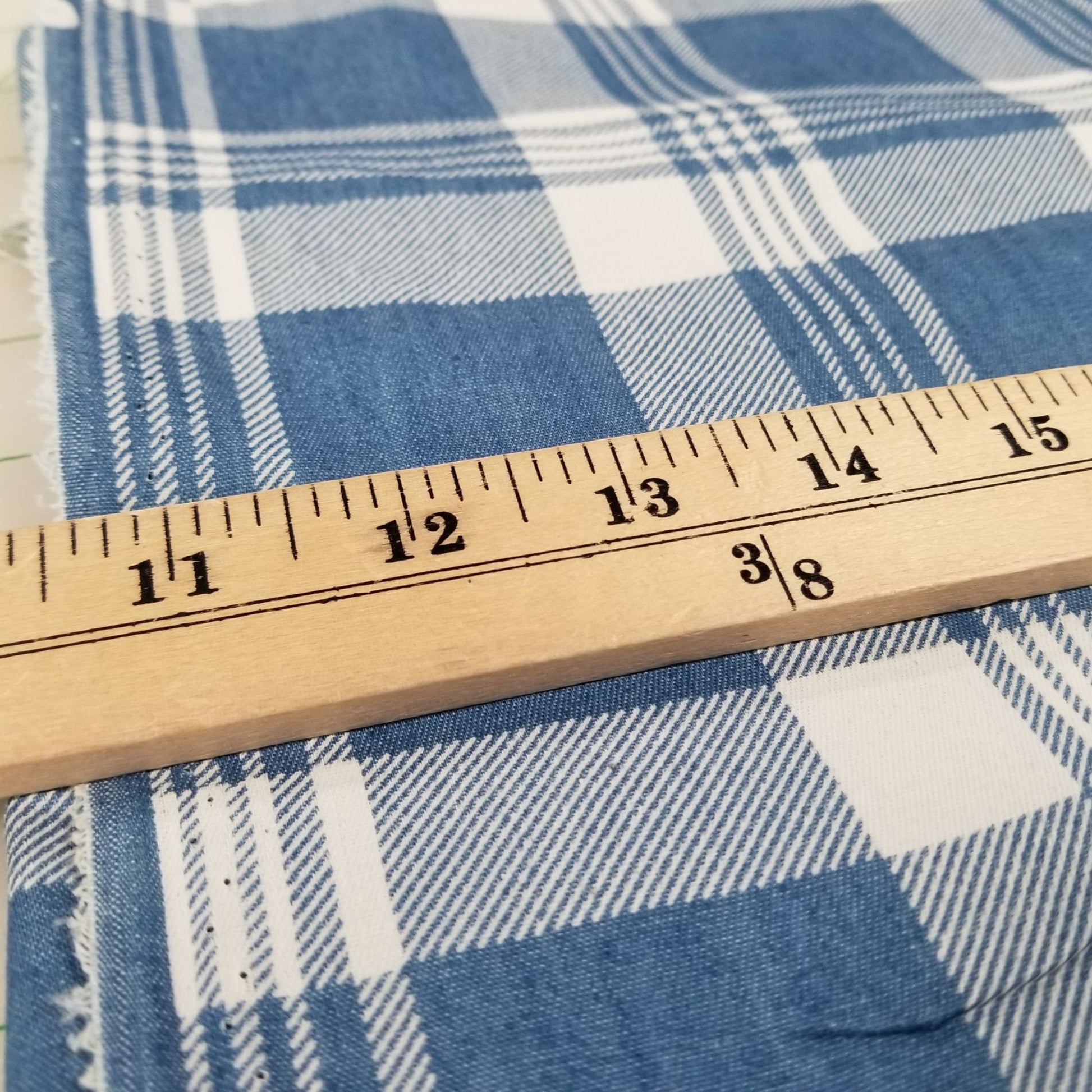 Blue and white checkered fabric with a wooden ruler for scale.