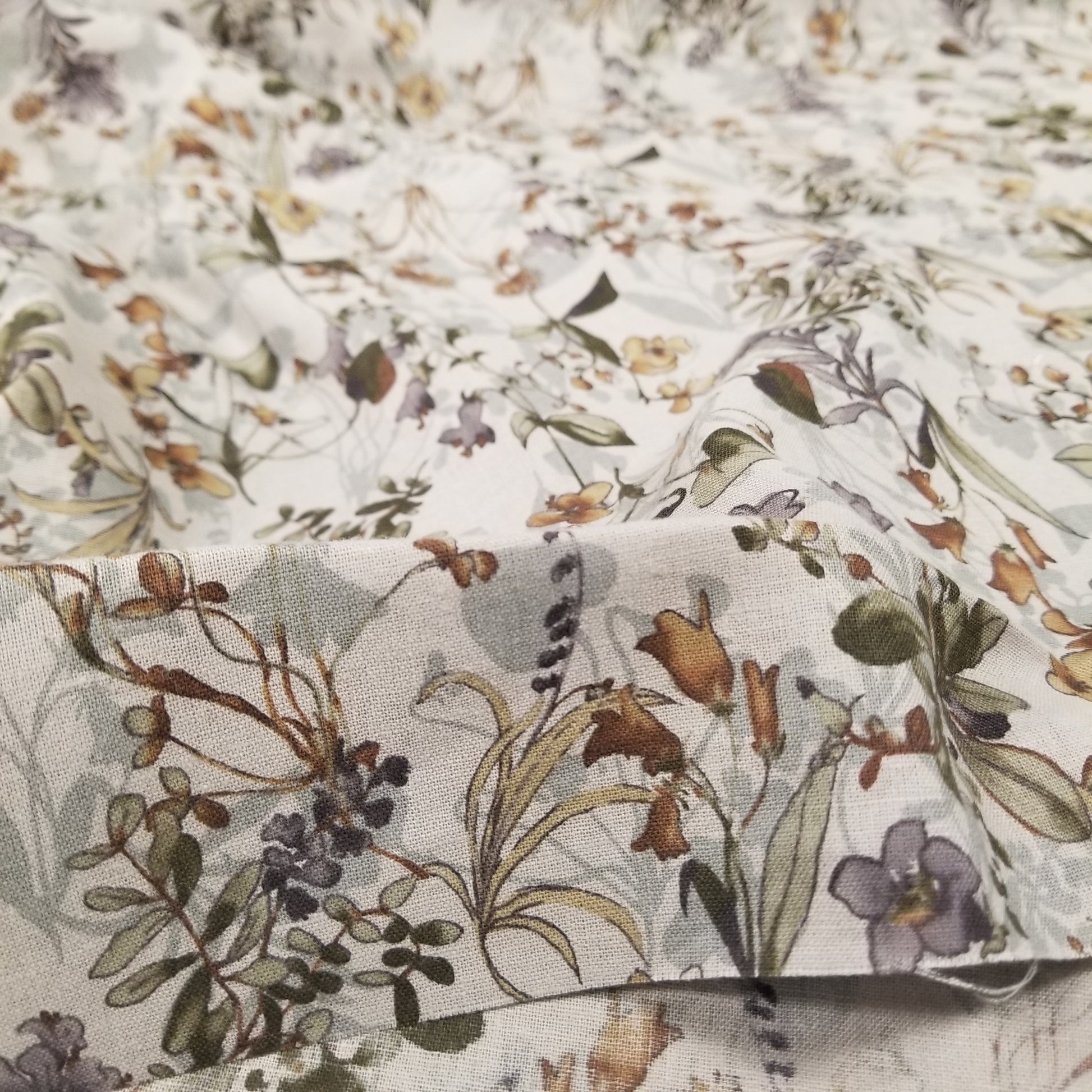 Close-up of floral fabric with a neutral color palette