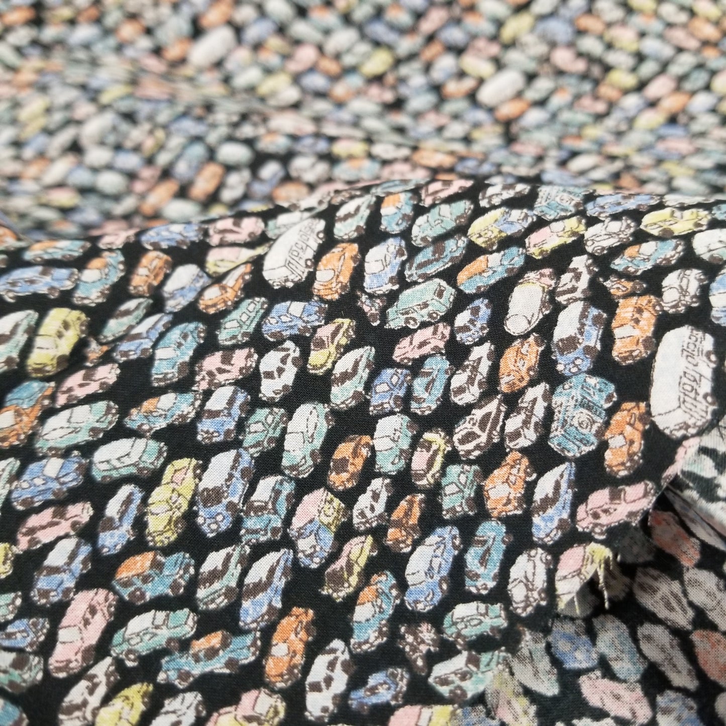 Close-up of a patterned fabric with colorful shapes on a black background