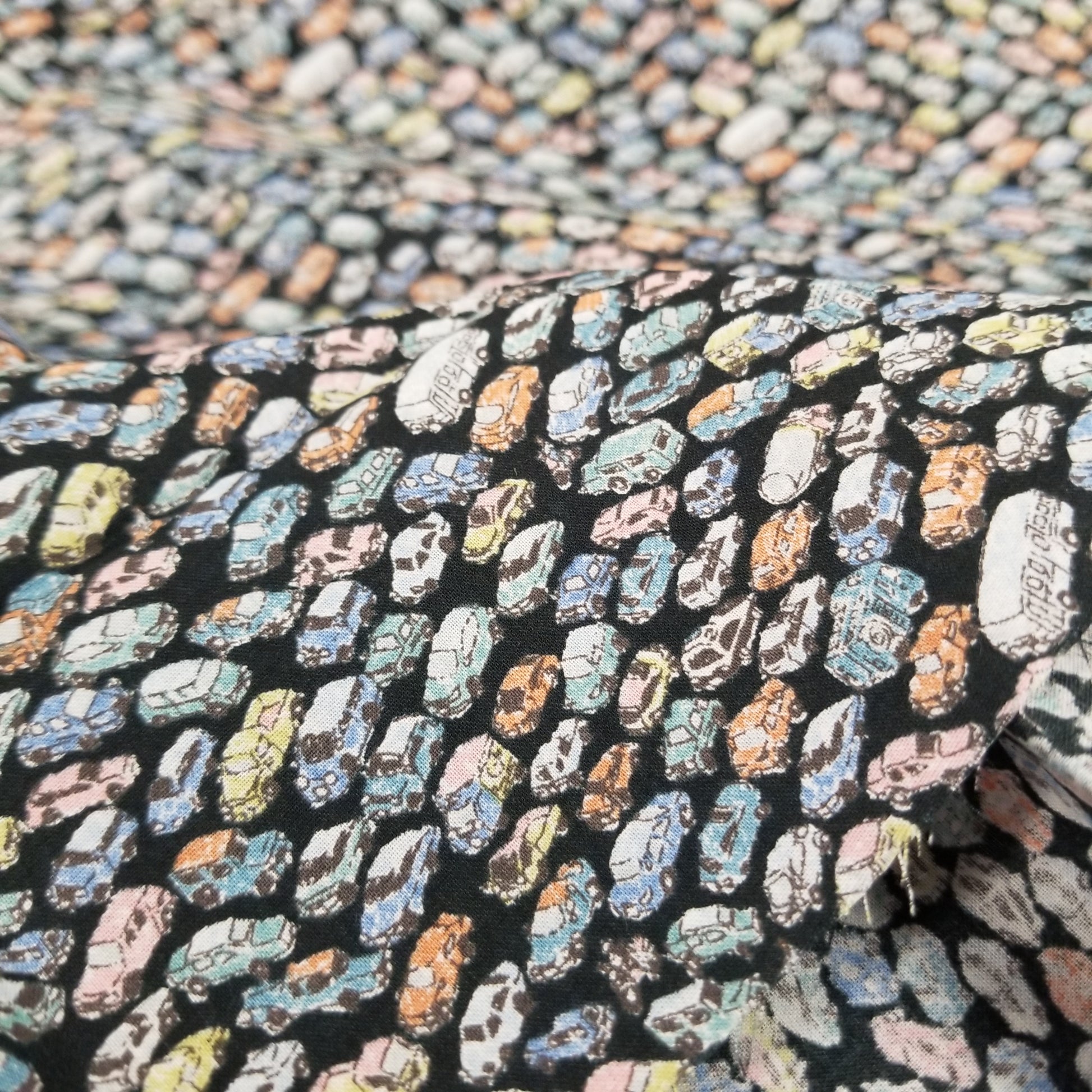 Close-up of a patterned fabric with colorful shapes on a black background