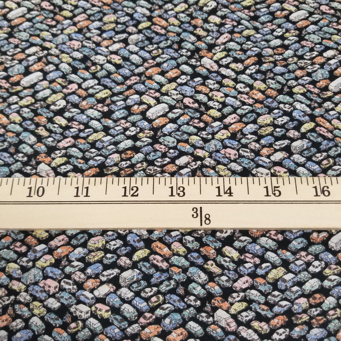 Patterned fabric with a ruler for scale on a black background