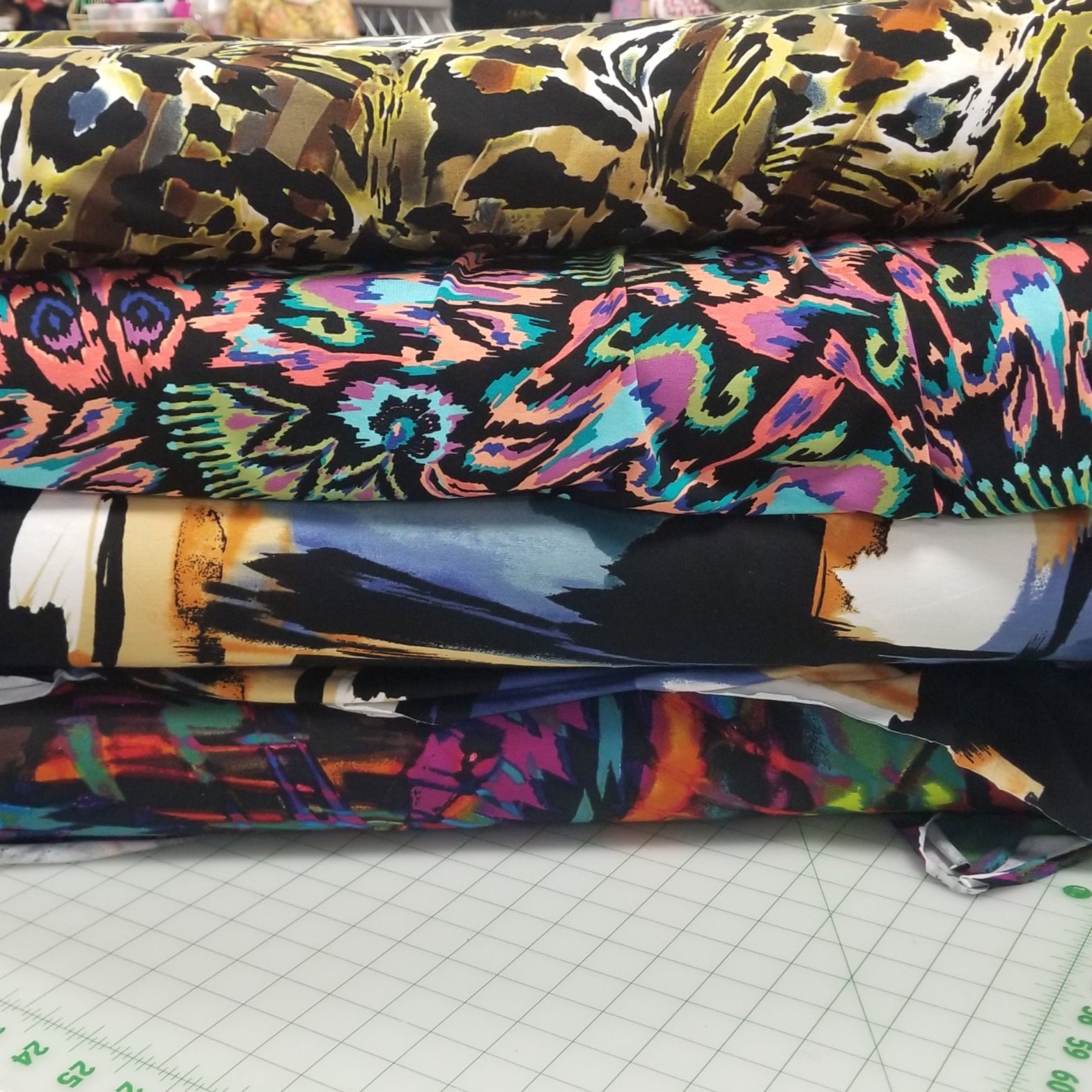 Colorful fabric swatches on a cutting mat with a ruler