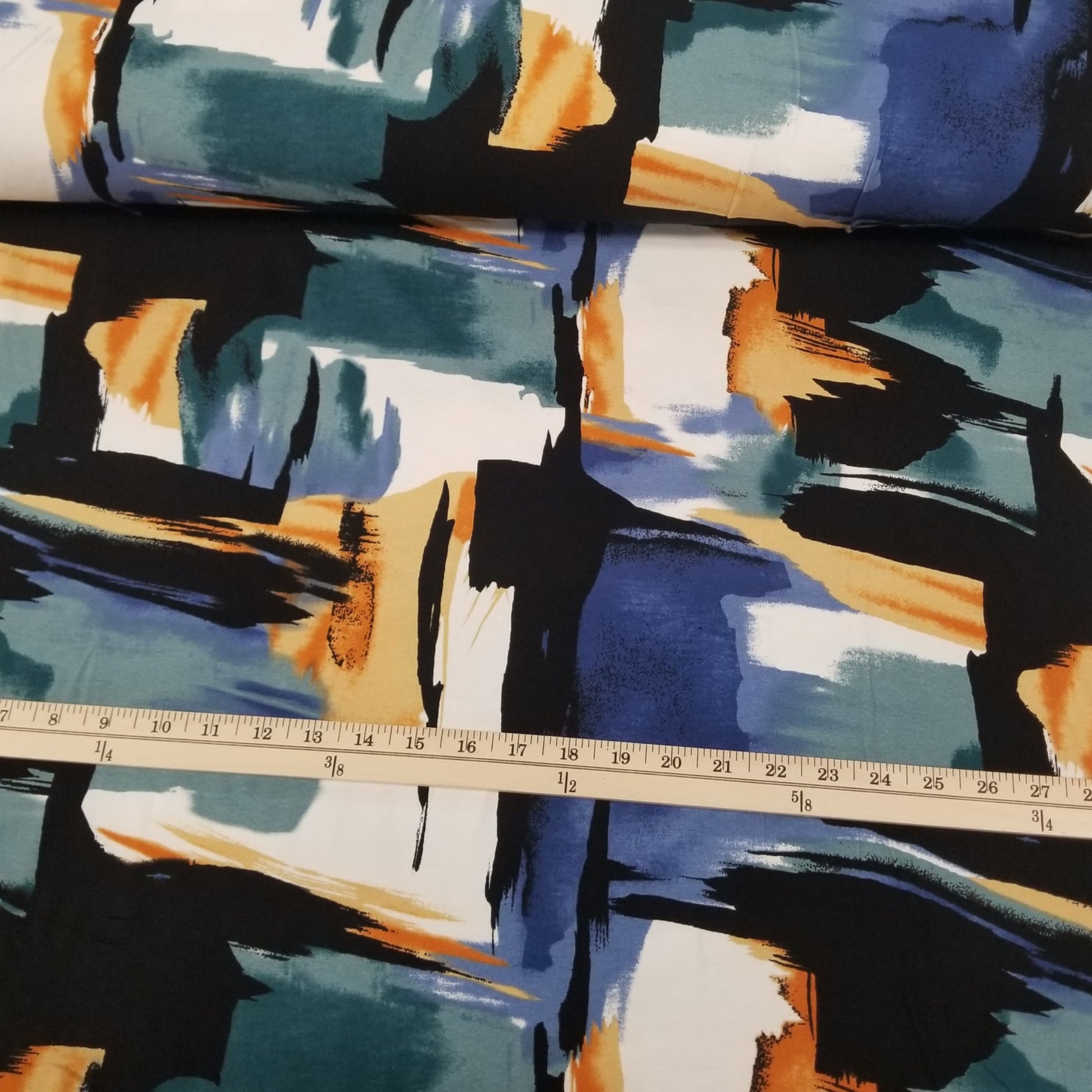 Colorful abstract patterned fabric with a ruler for scale