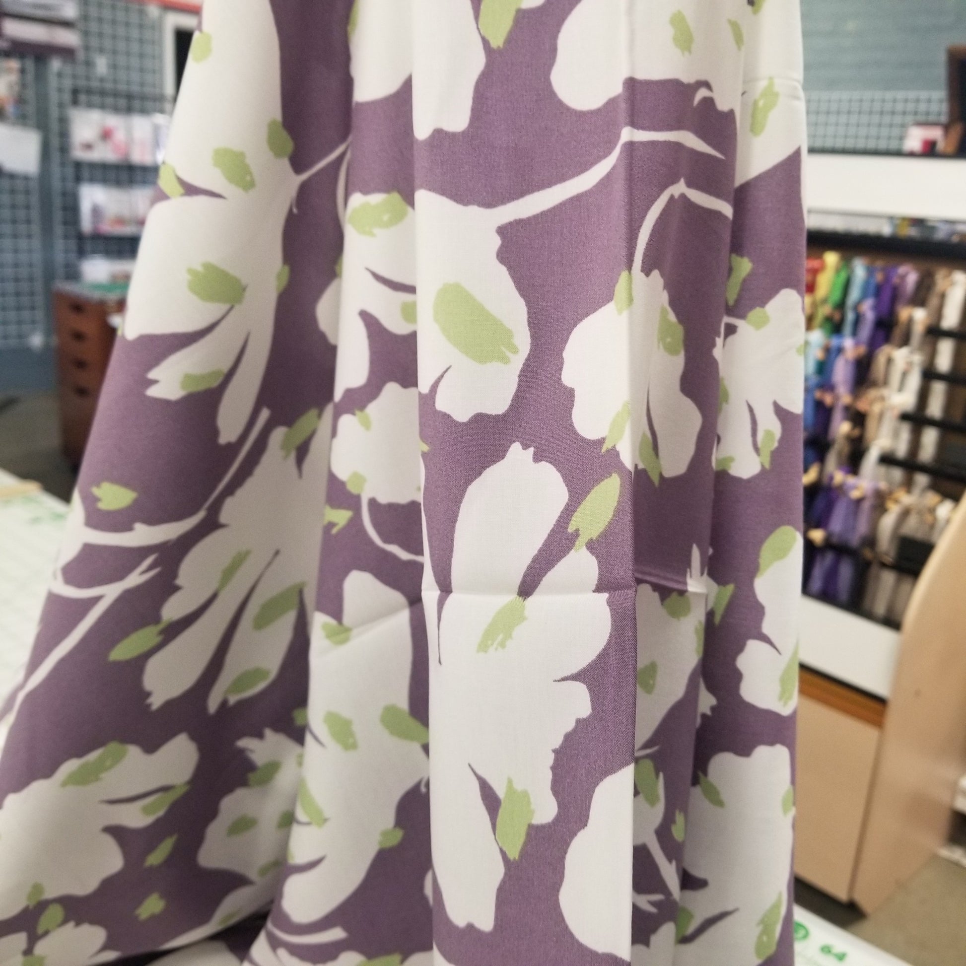 Floral fabric with white flowers on a purple background