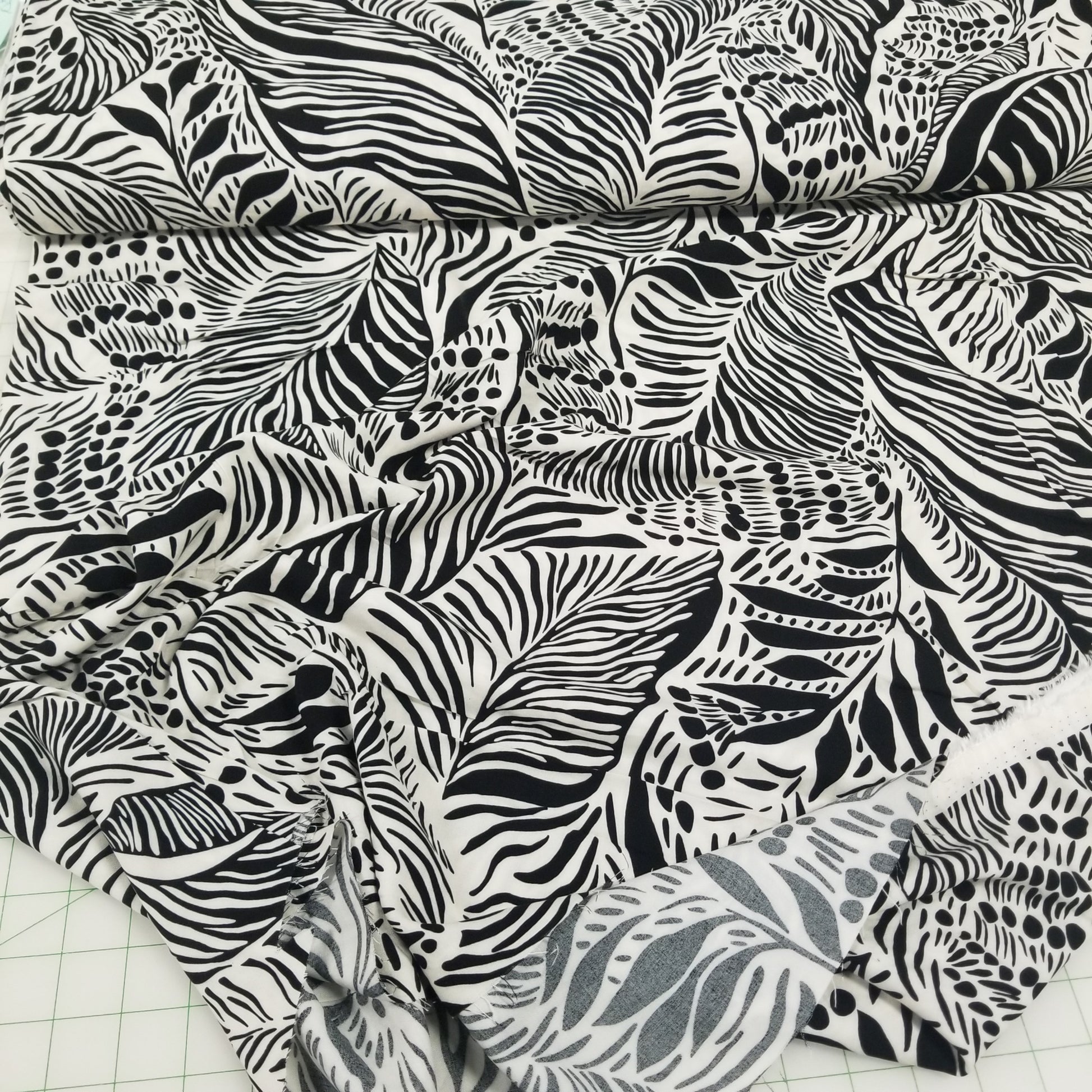 Fabric with black and white zebra pattern on a grid background
