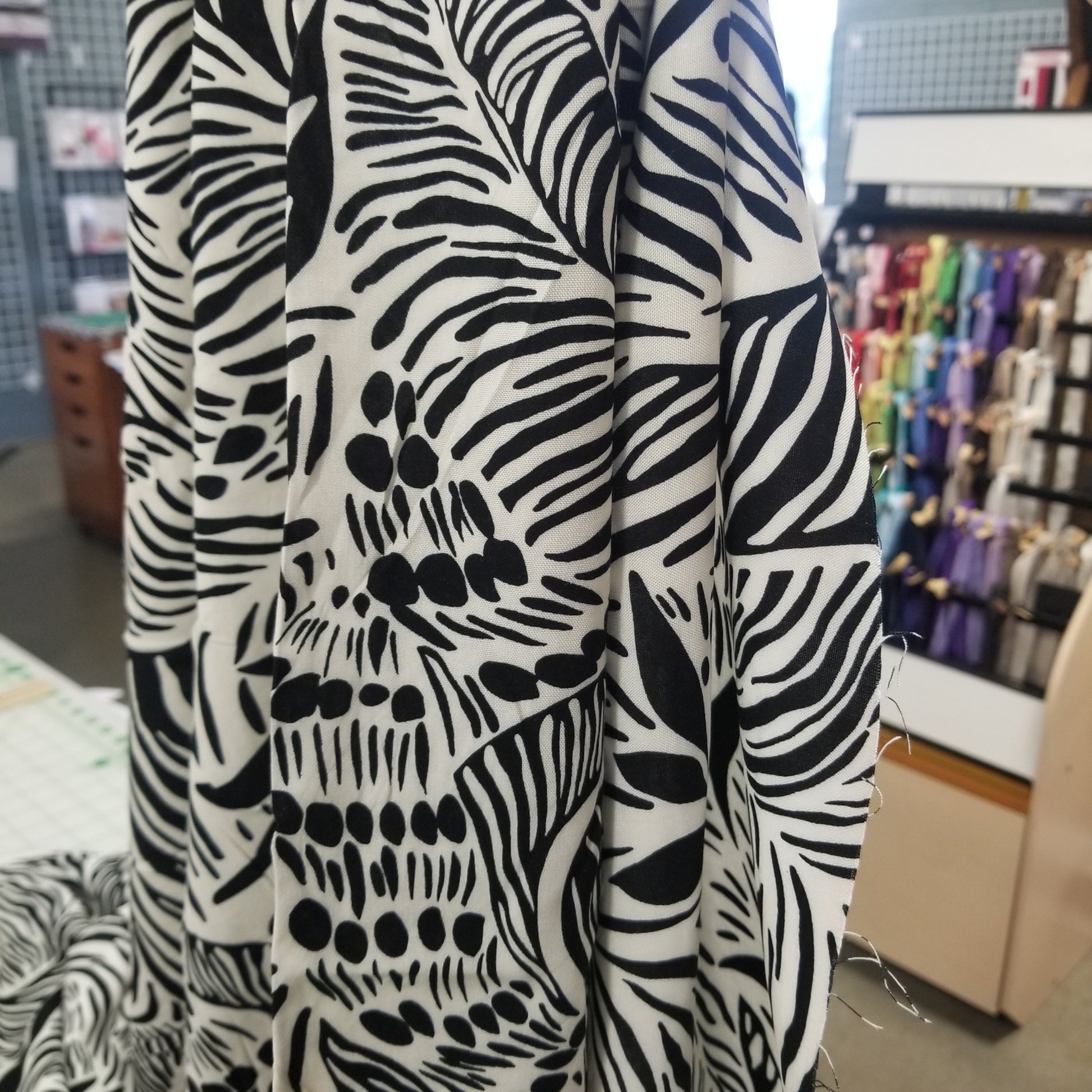 Stack of black and white patterned fabric with a blurred background