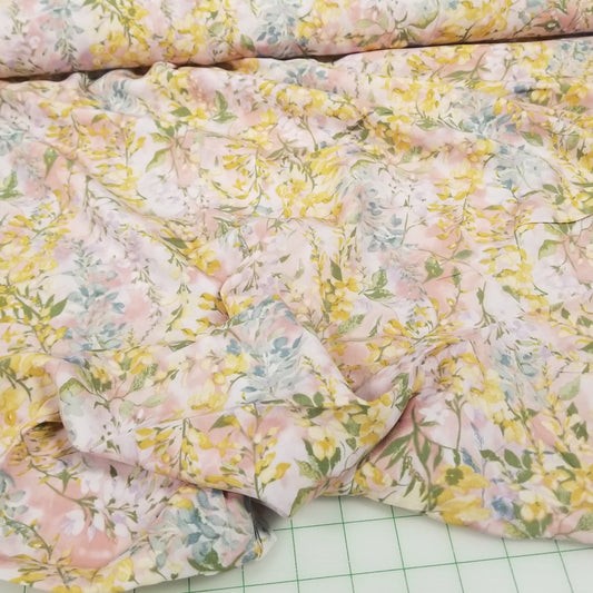 Floral fabric on a green cutting mat with grid lines